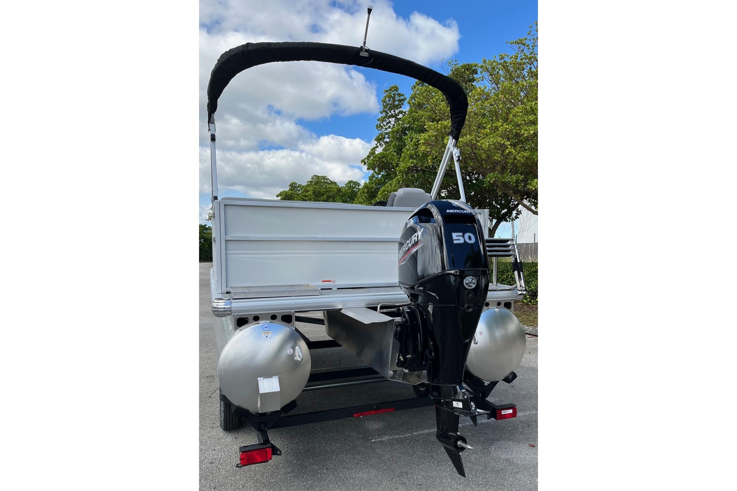 2026 Sun Tracker Party Barge 16 DLX with Mercury 50 outboard motor, rear view.