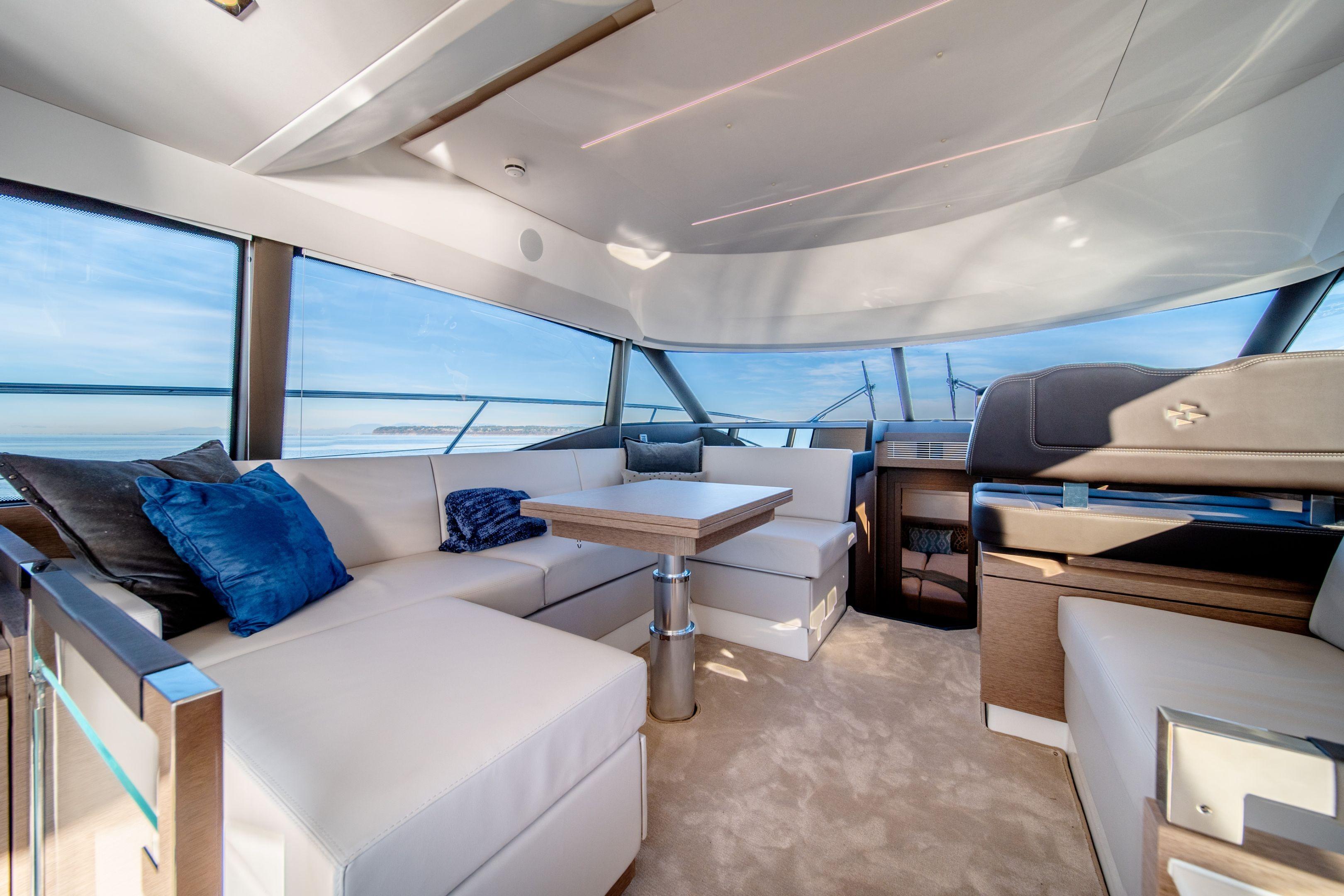 Luxurious interior of 2026 Prestige 460 yacht with elegant seating and panoramic windows.