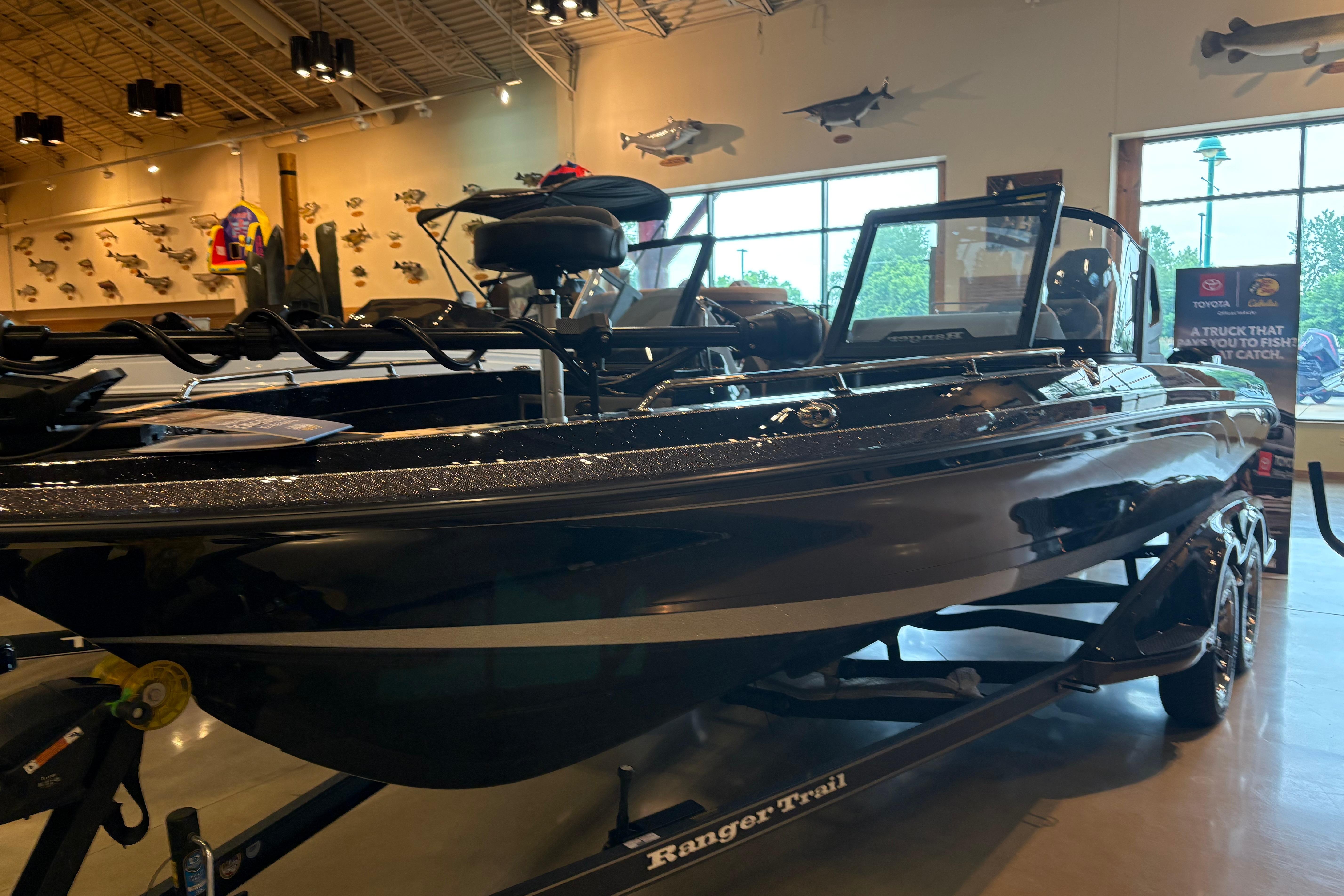 2026 Ranger 621FS Cup-Equipped boat displayed indoors with fishing decor.