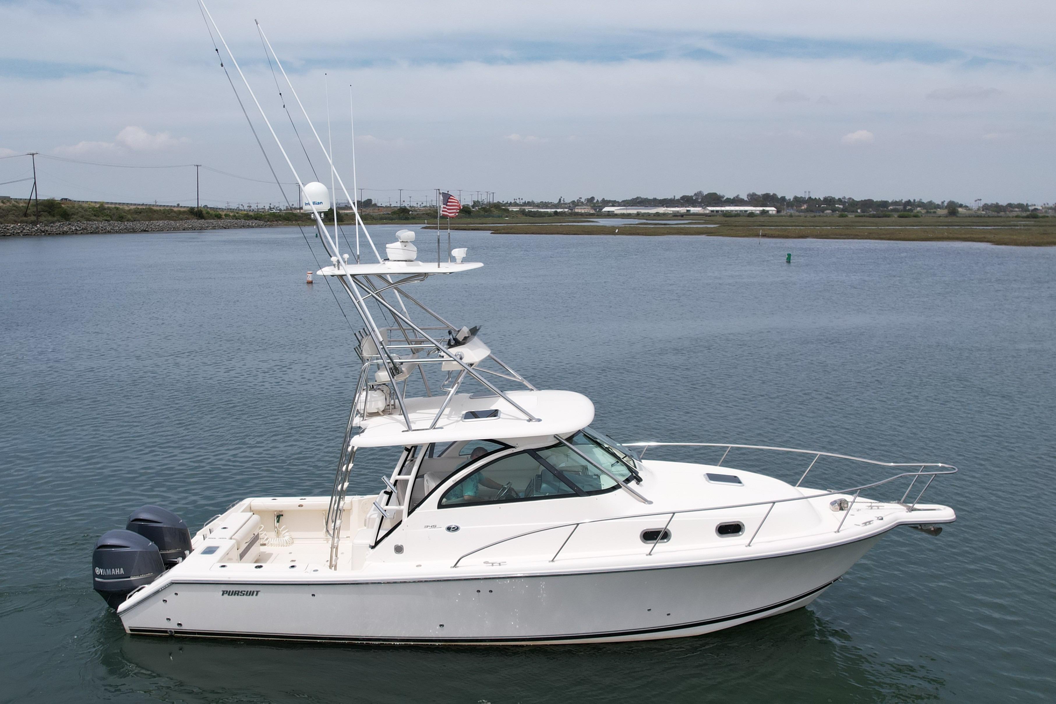 2012 Pursuit OS 345 Offshore boat on calm water, featuring dual Yamaha engines.