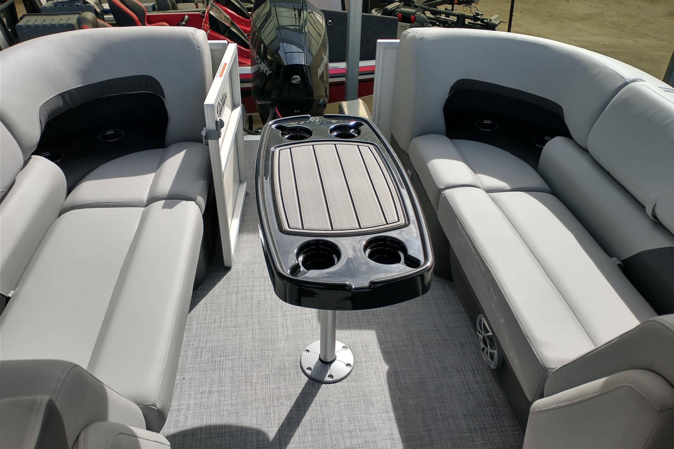 2026 Sun Tracker Party Barge 22 XP3 interior with plush seating and central table.