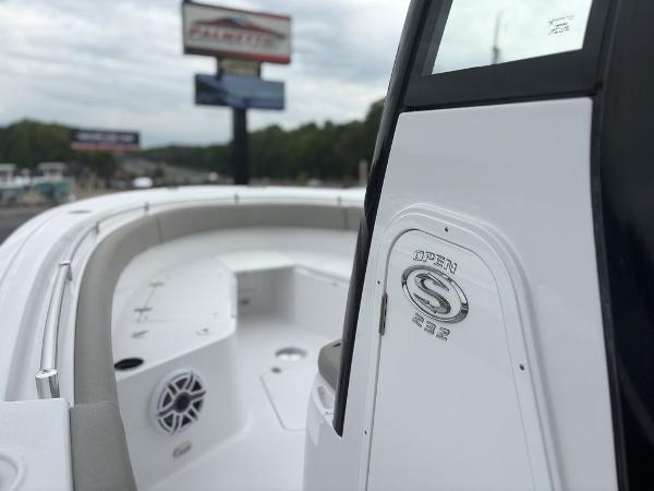 2025 Sportsman Open 232 boat, sleek design, white interior, outdoor display.
