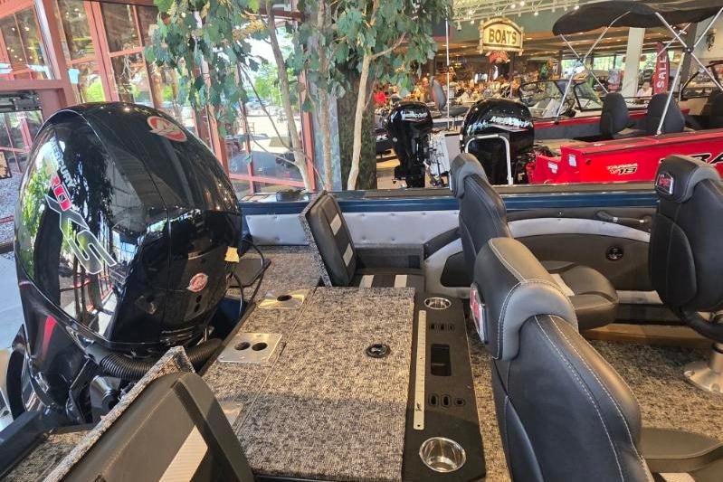 2026 Ranger VX1788 WT boat interior with seating and motor display in showroom.