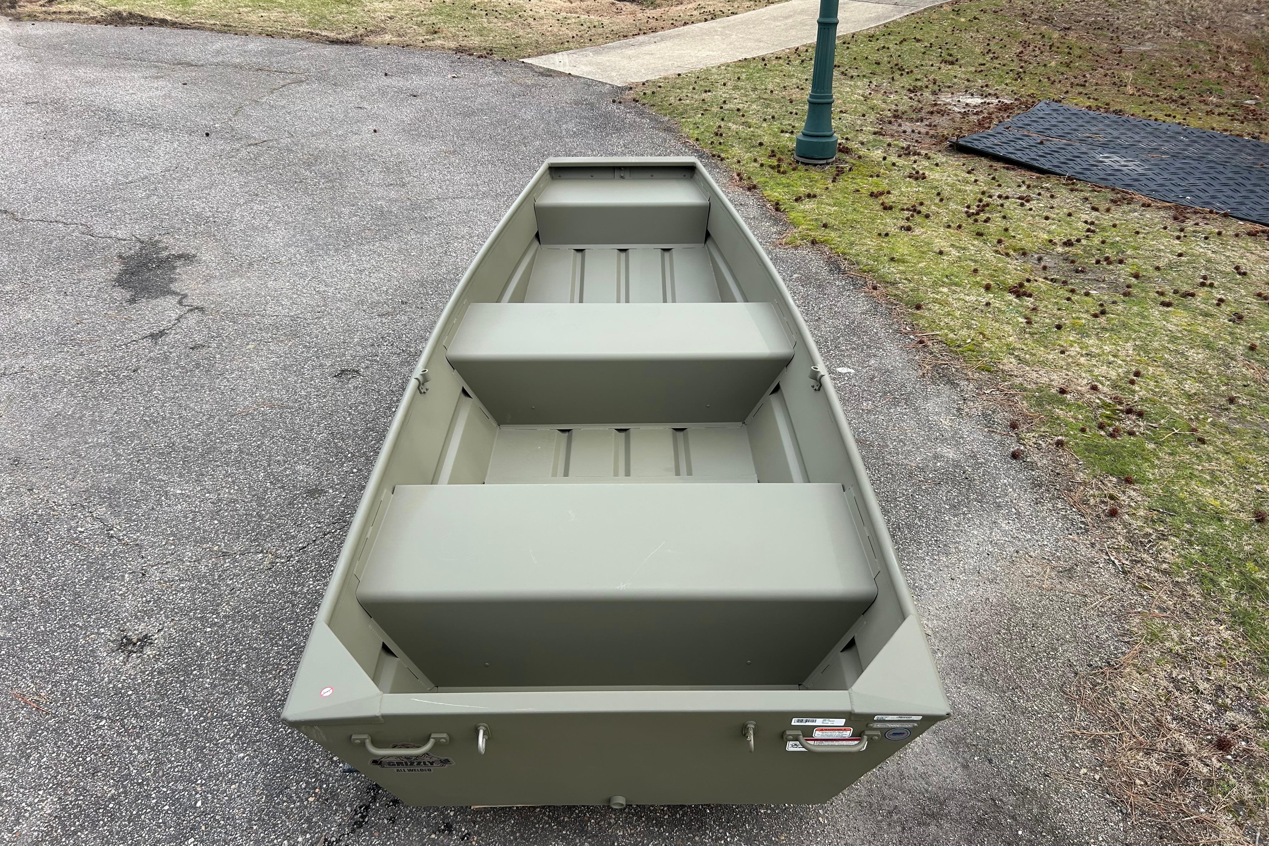 2026 Tracker Grizzly 12 Jon boat on pavement, showcasing its sturdy design.