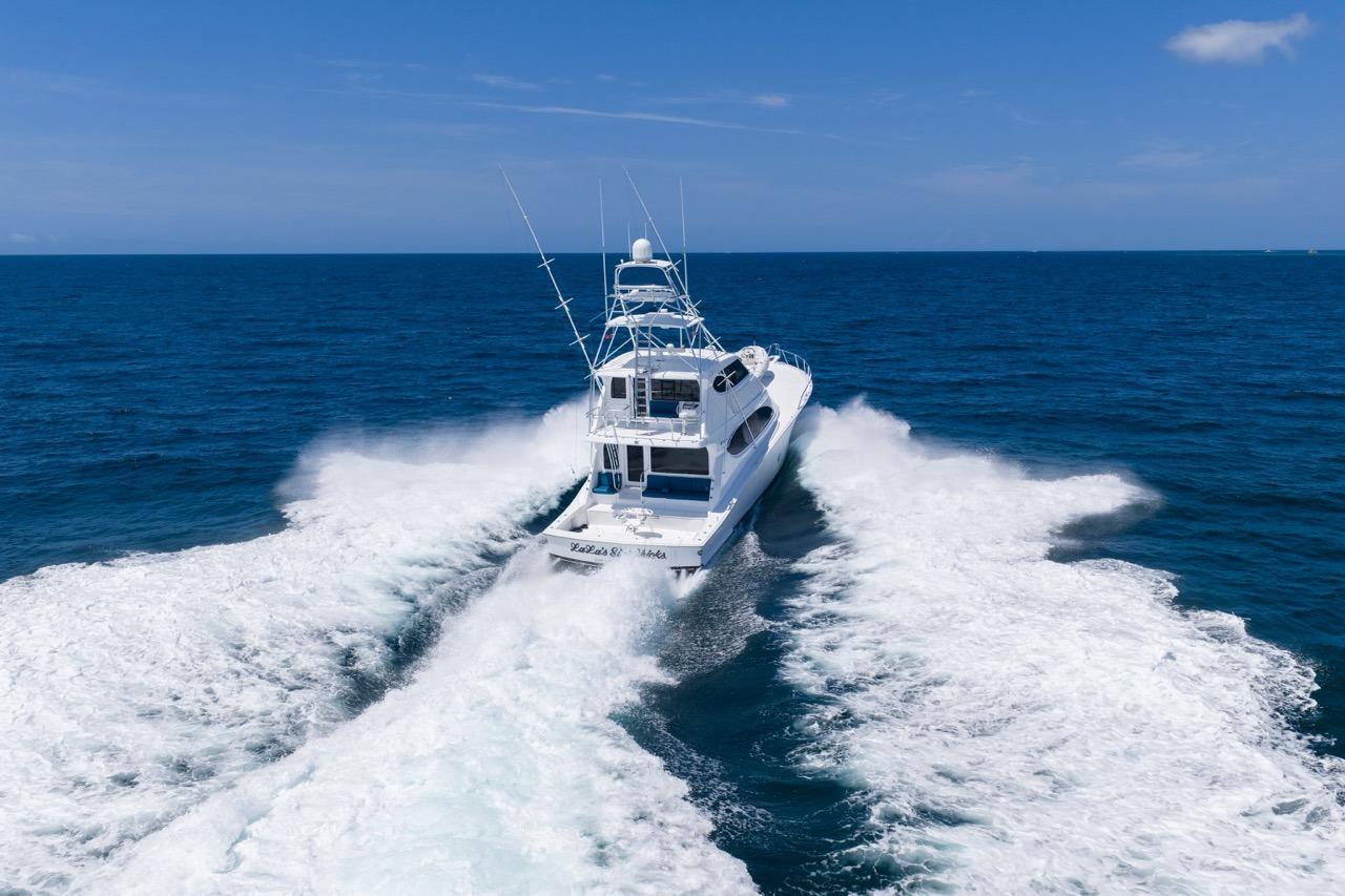 2008 Hatteras 77 Convertible yacht cruising on open ocean waters.