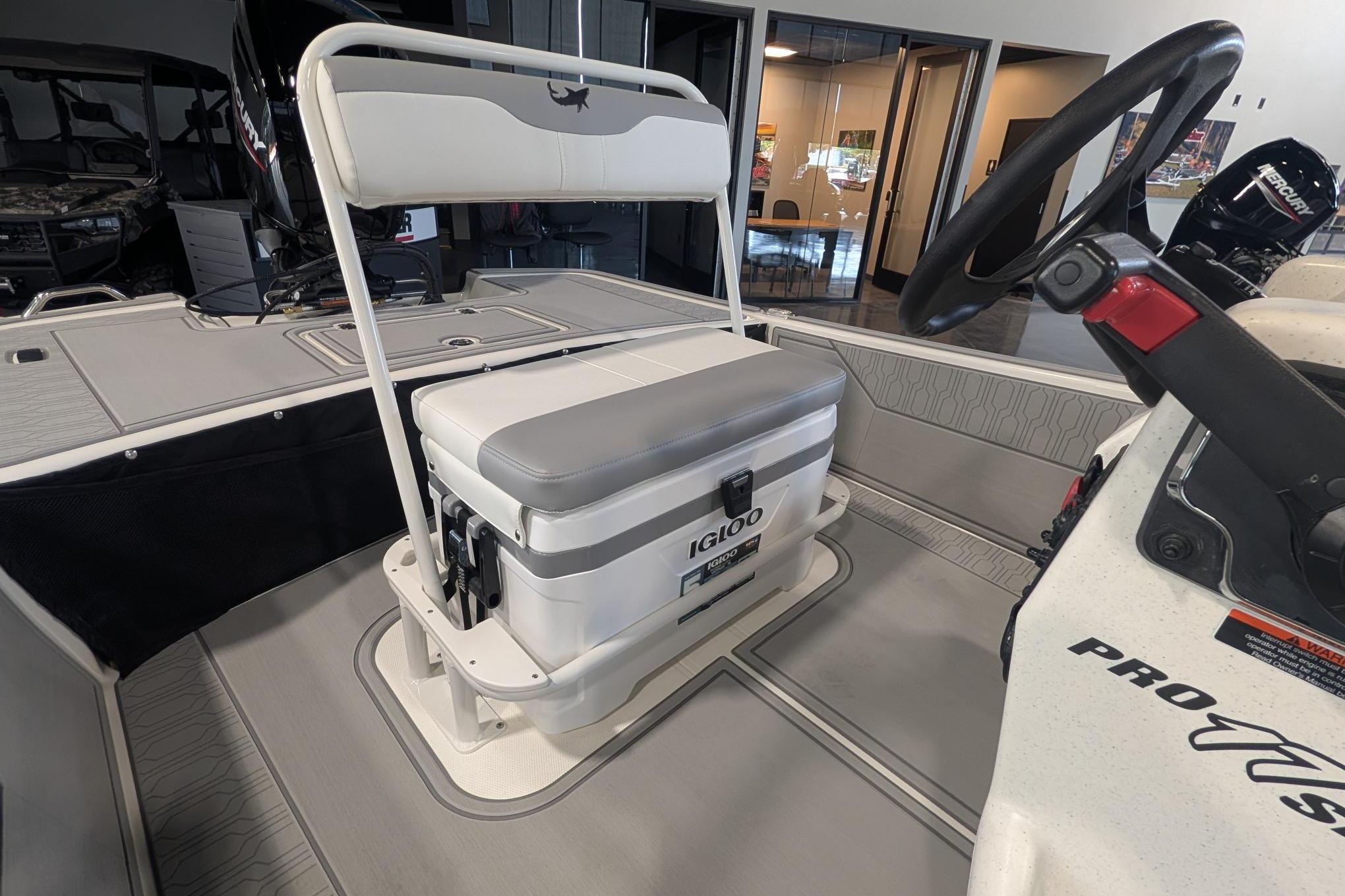 2026 Mako Pro Skiff 17 CC boat interior with Igloo cooler seat and steering wheel.