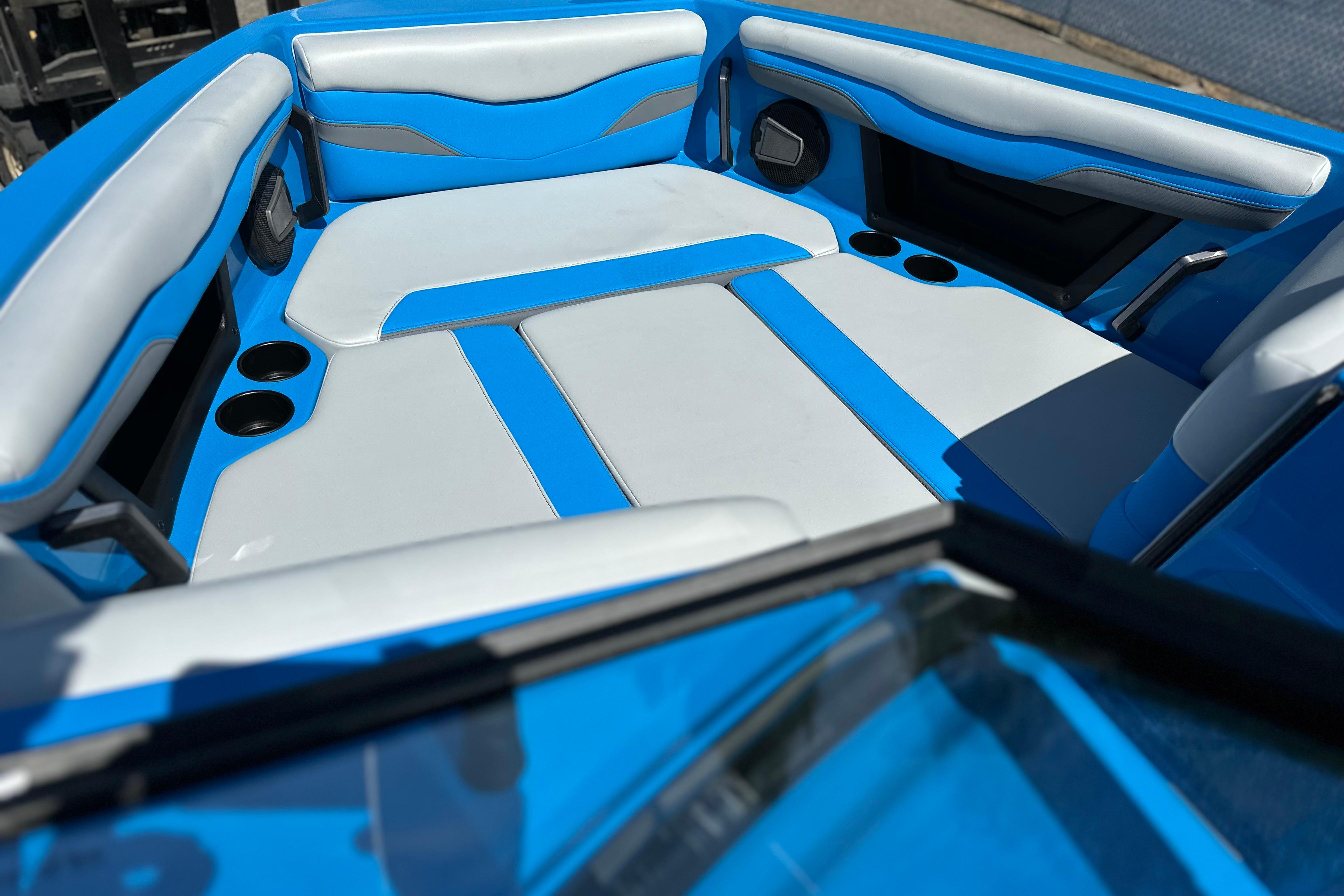 2026 Axis T235 boat interior with blue and white seating, cup holders, and sleek design.