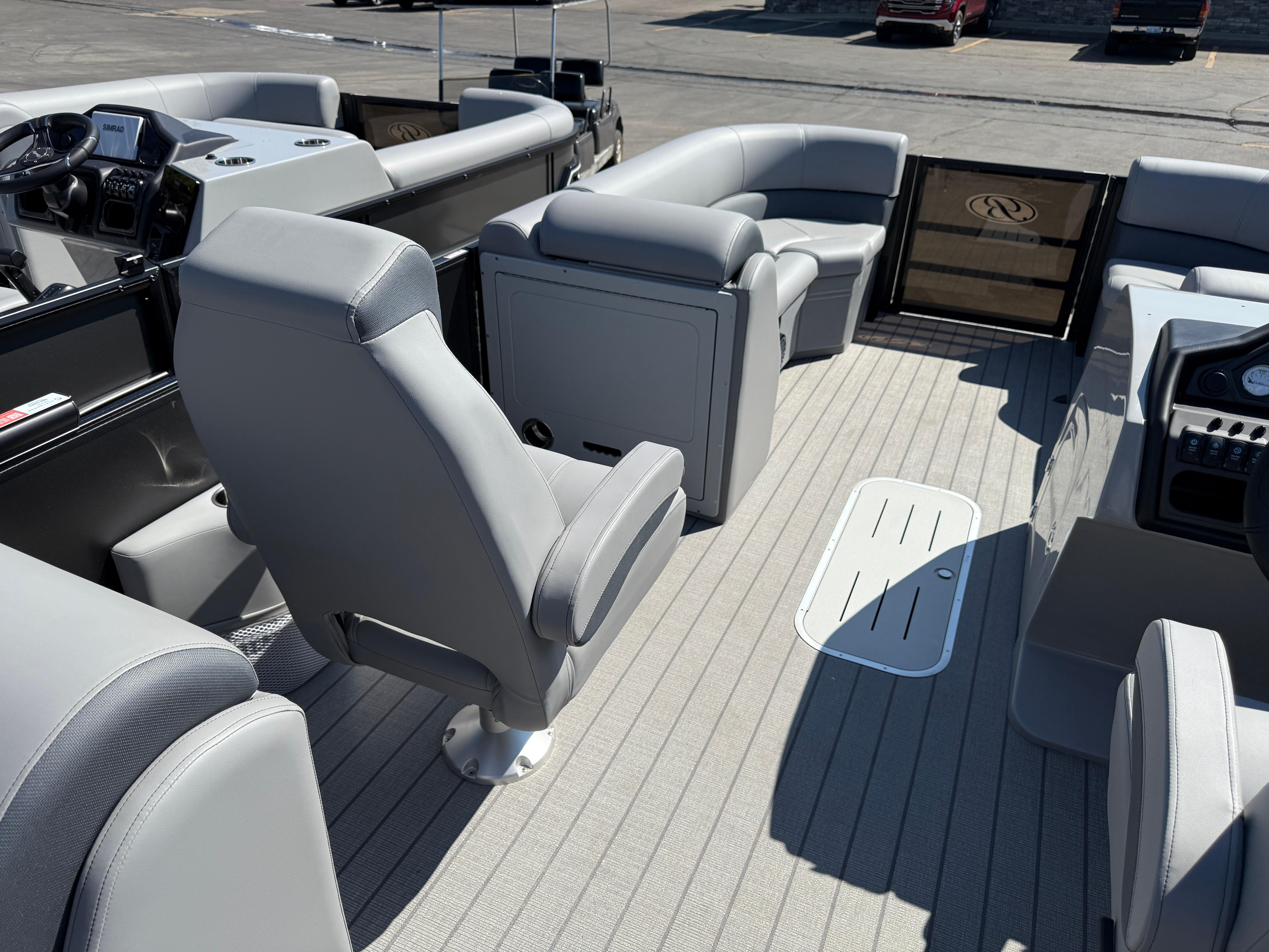 Interior of 2026 Bentley Pontoons Legacy 223 Navigator with gray seating and modern dashboard.