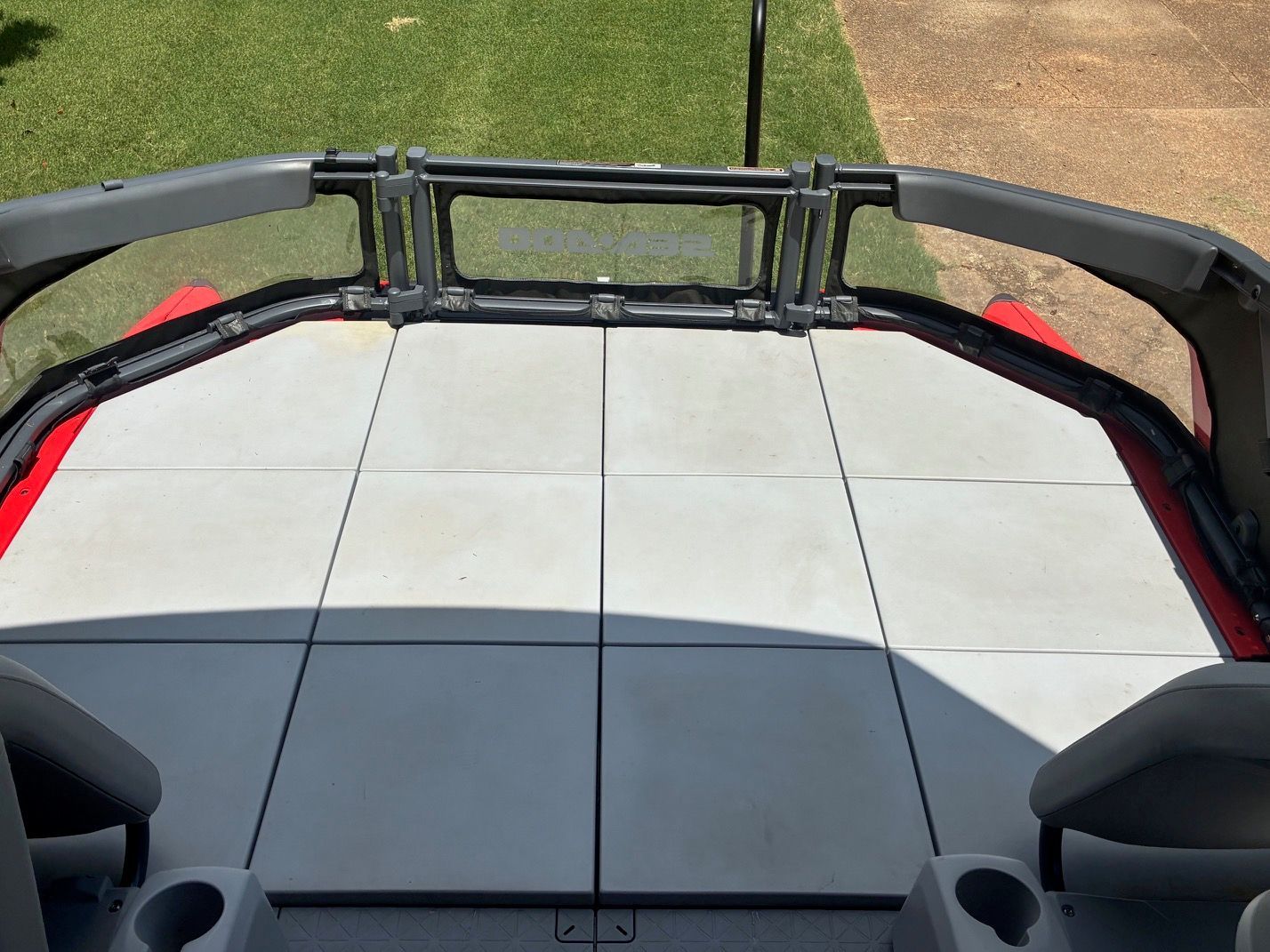 The image shows the deck of a 2023 Sea-Doo Switch Sport 18 with gray tiles.