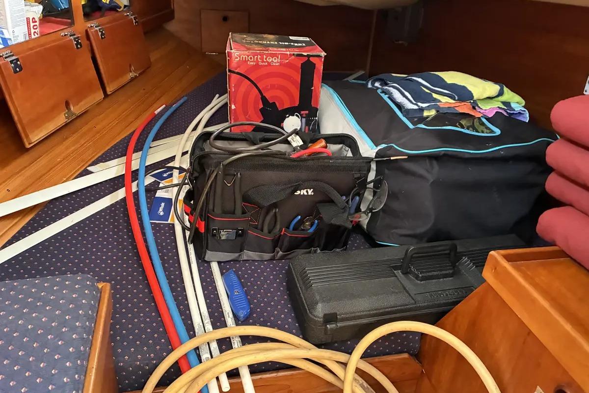Interior of a 1998 Sabre 36 sailboat with tools and equipment organized.