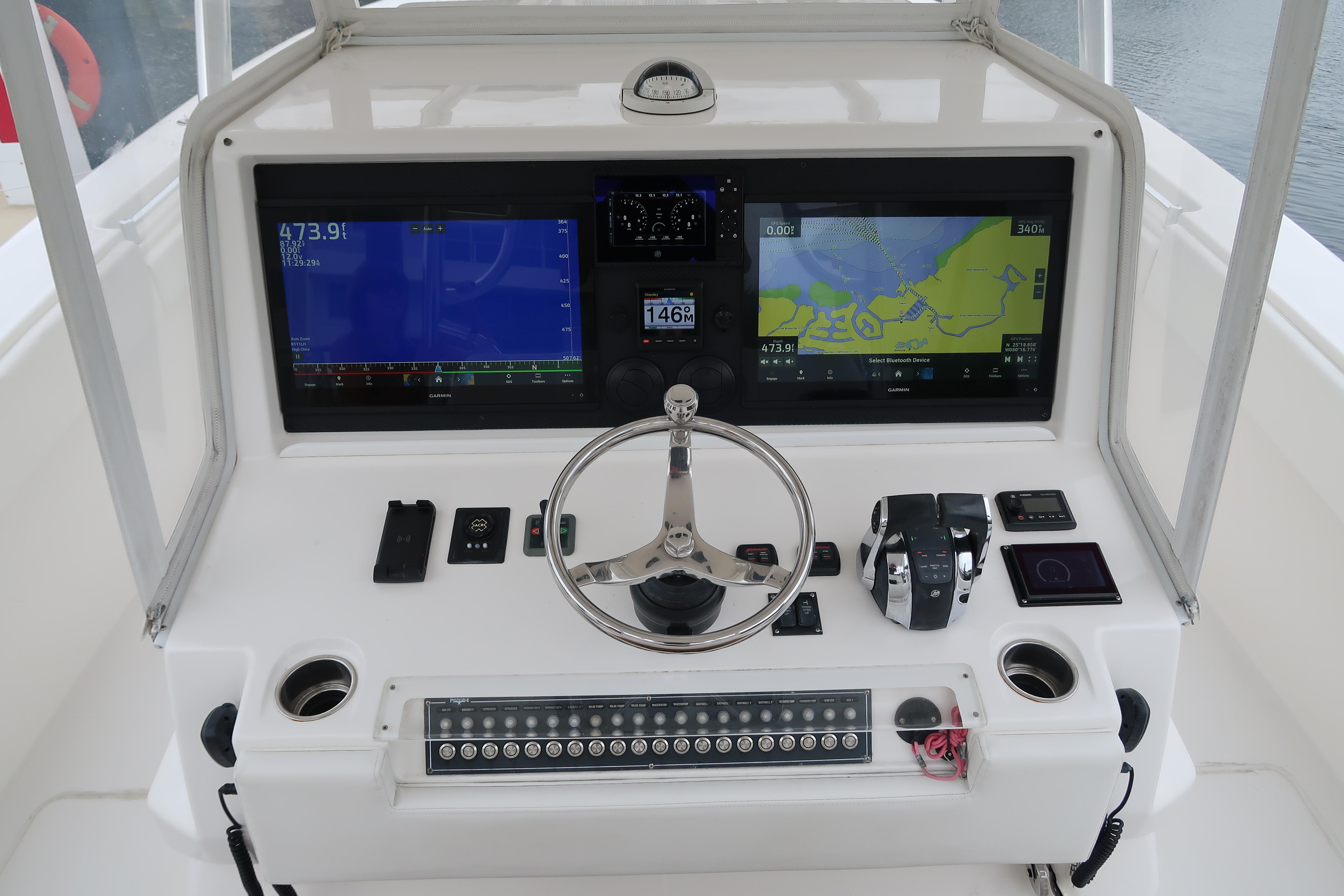 2016 Invincible 42 Open Fisherman boat dashboard with dual navigation screens and controls.