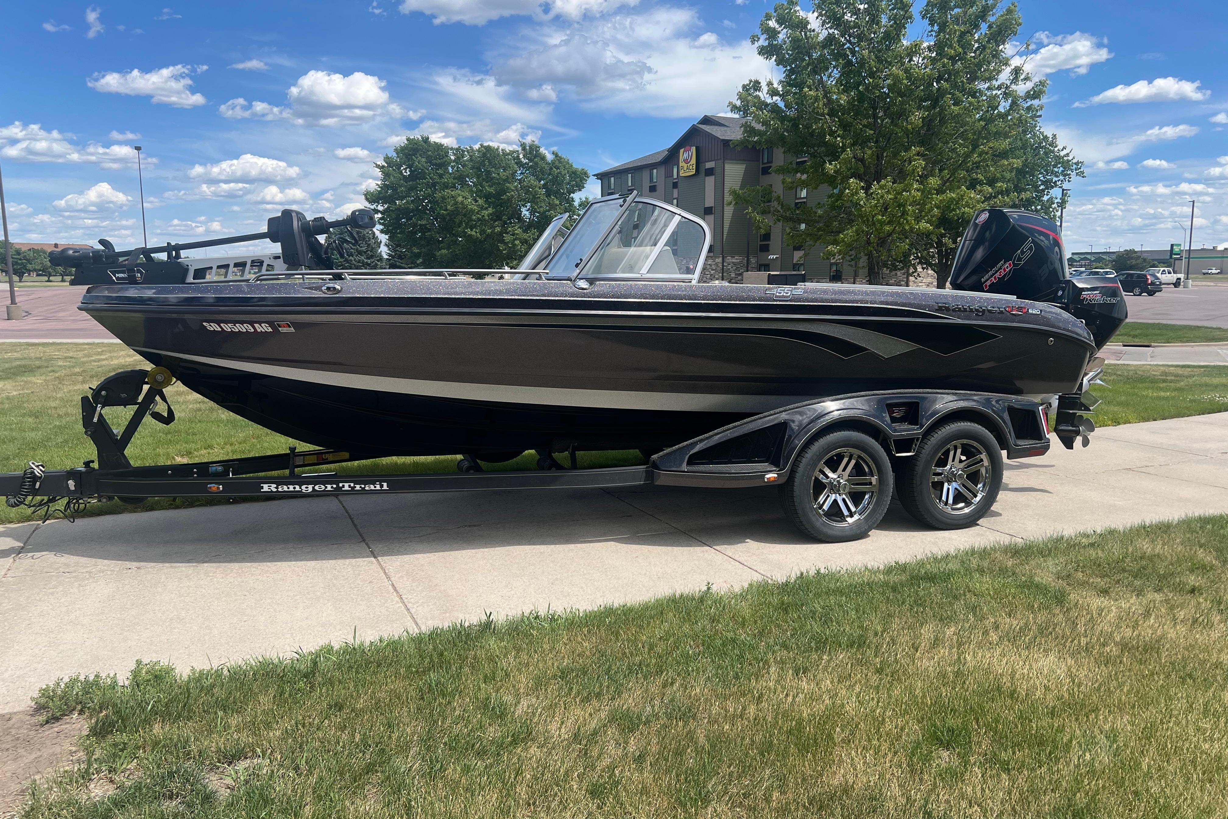 2023 Ranger 620FS Pro boat on trailer, parked outdoors under a blue sky.