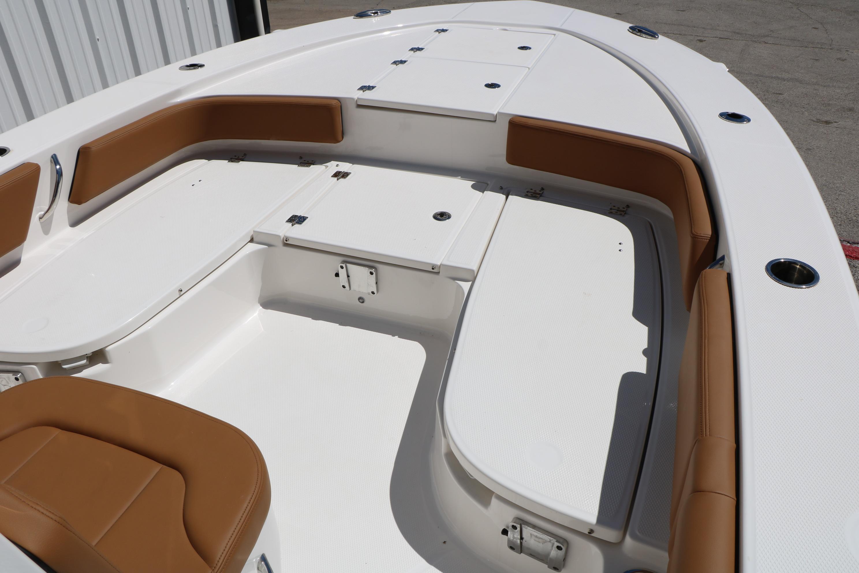 2026 Robalo 246 Cayman boat interior with white deck and tan seating.