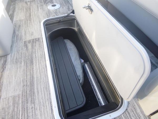2024 Ranger Reata 223C boat storage compartment with open lid, showcasing interior space.