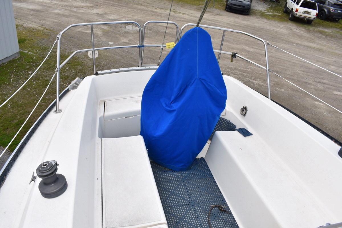 The deck of a 1987 S2 9.2A with a blue cover and metal railing.