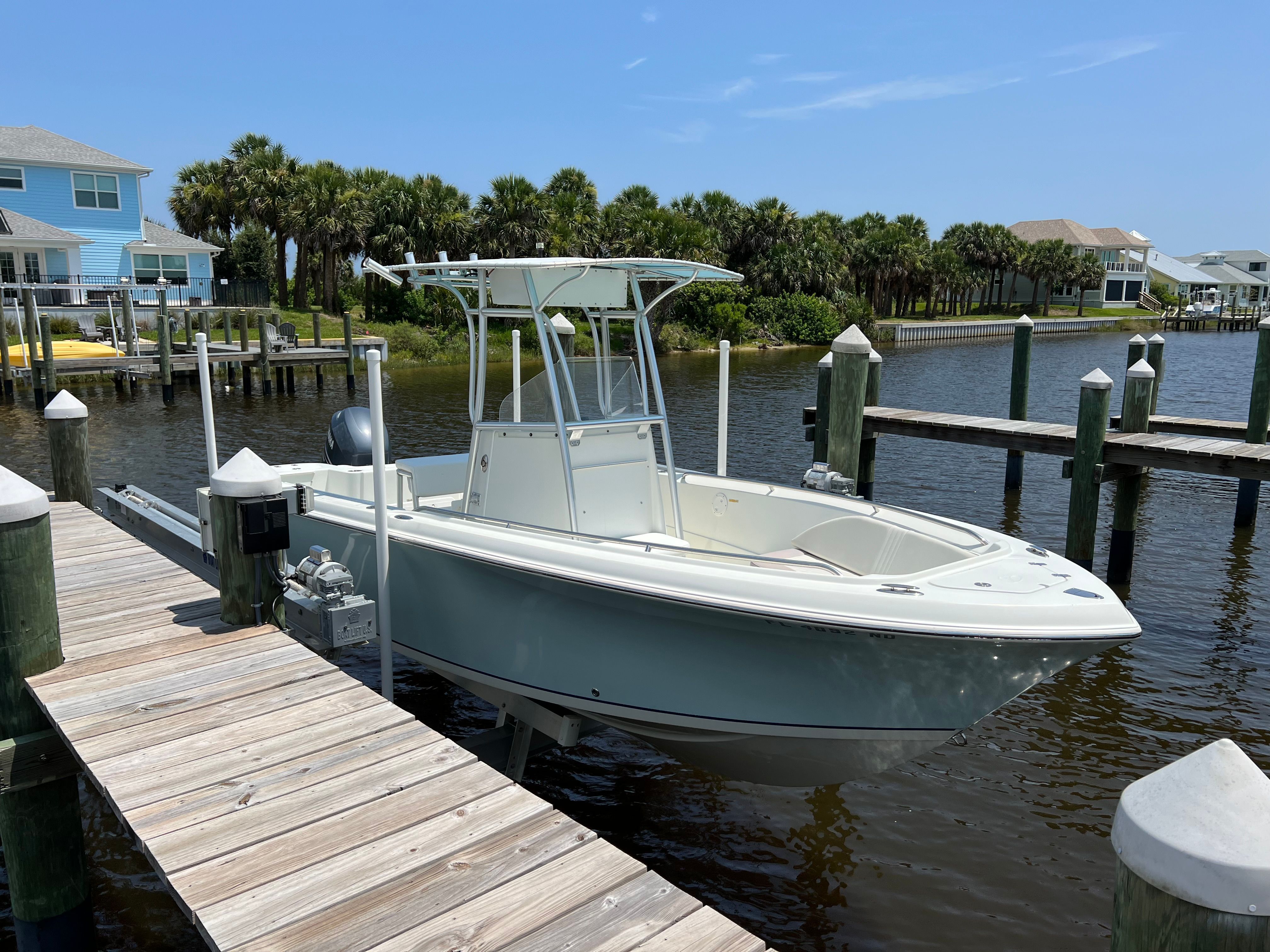 2006 Sailfish 218 CC boat docked by the water.