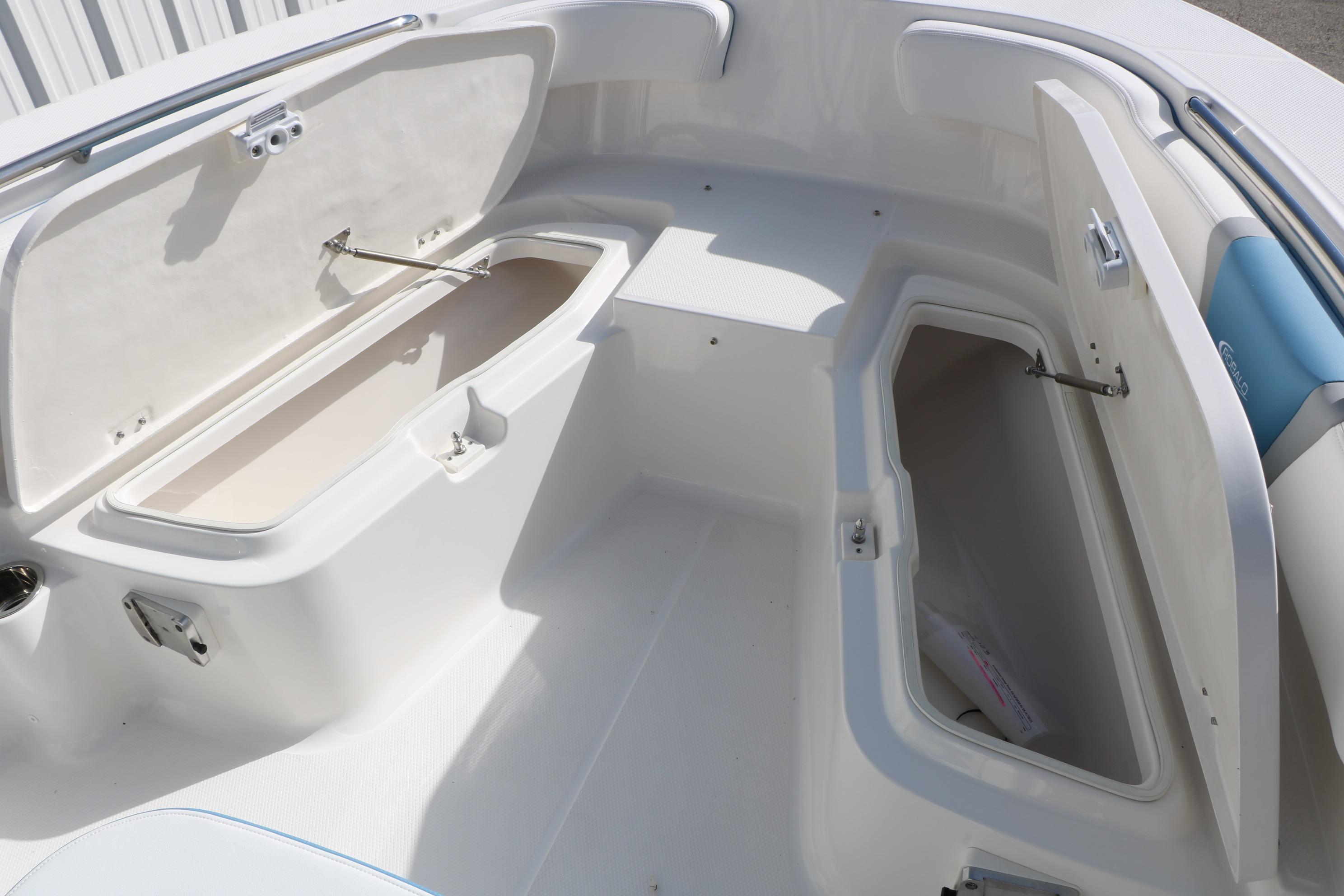 2026 Robalo R200 Center Console boat storage compartments open, showcasing spacious interior design.
