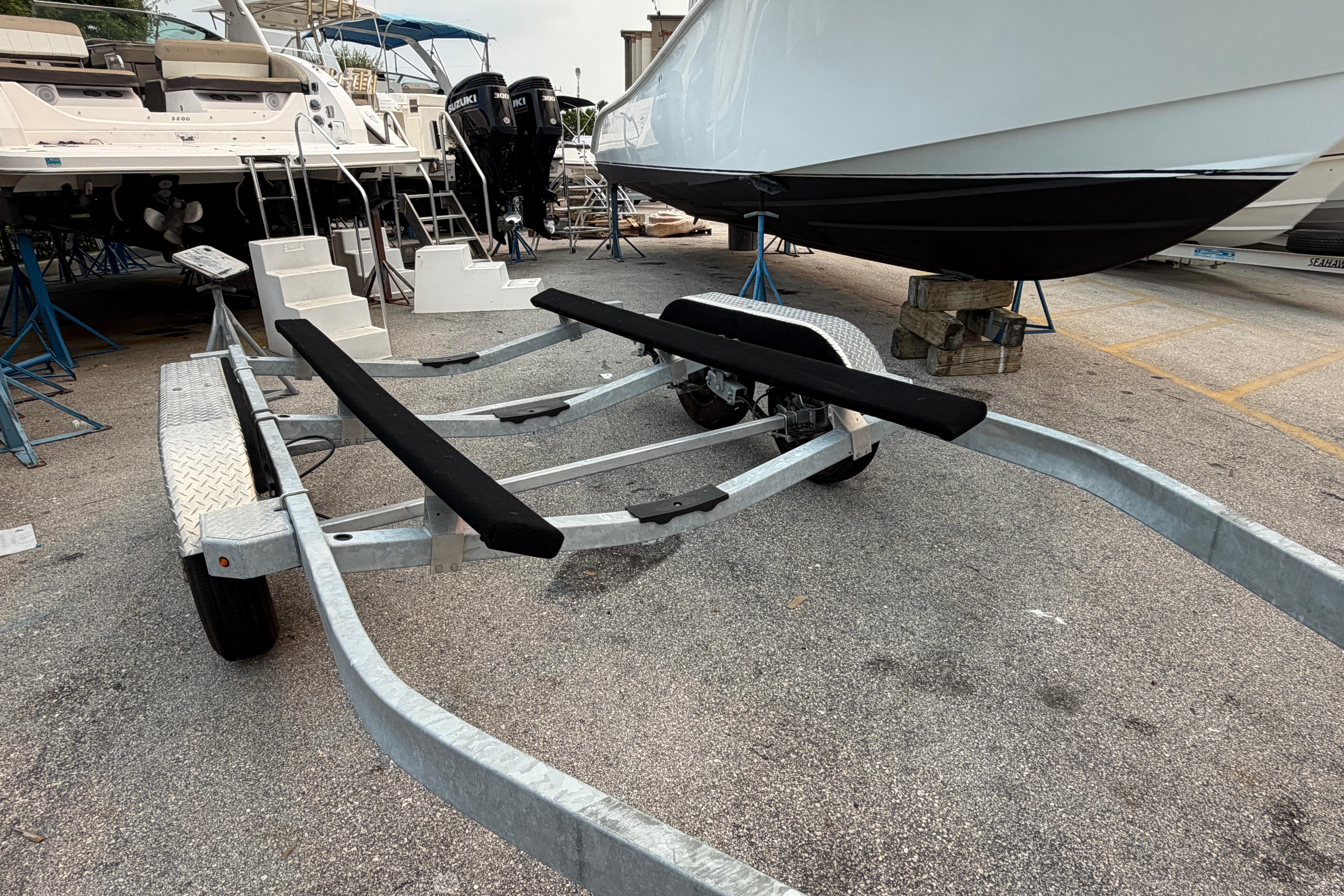 Boat trailer SRT5000, 2024 model, parked in marina with boats in background.