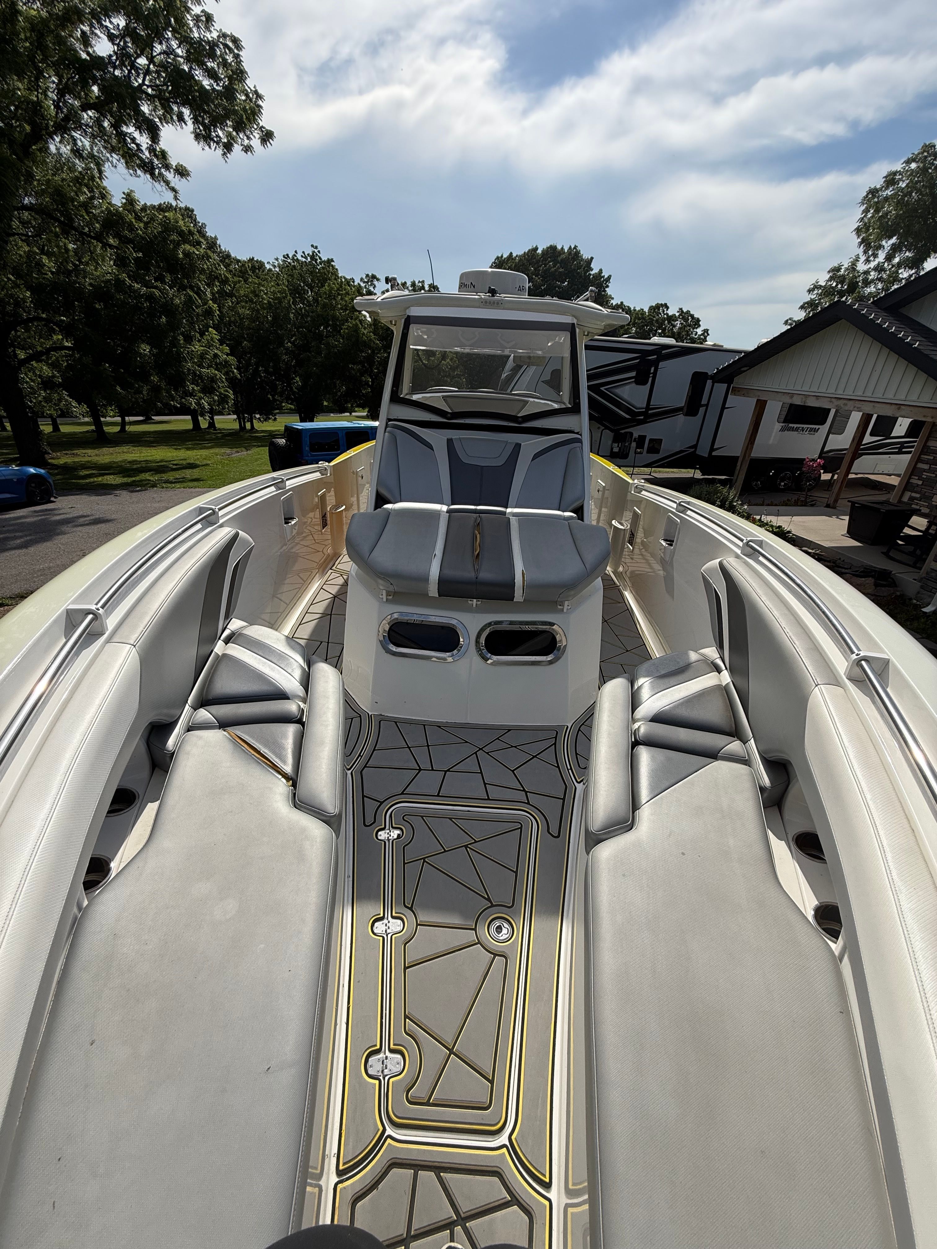 The image shows the deck of a 2014 Sunsation 34 CCX boat with sleek seating and modern design.