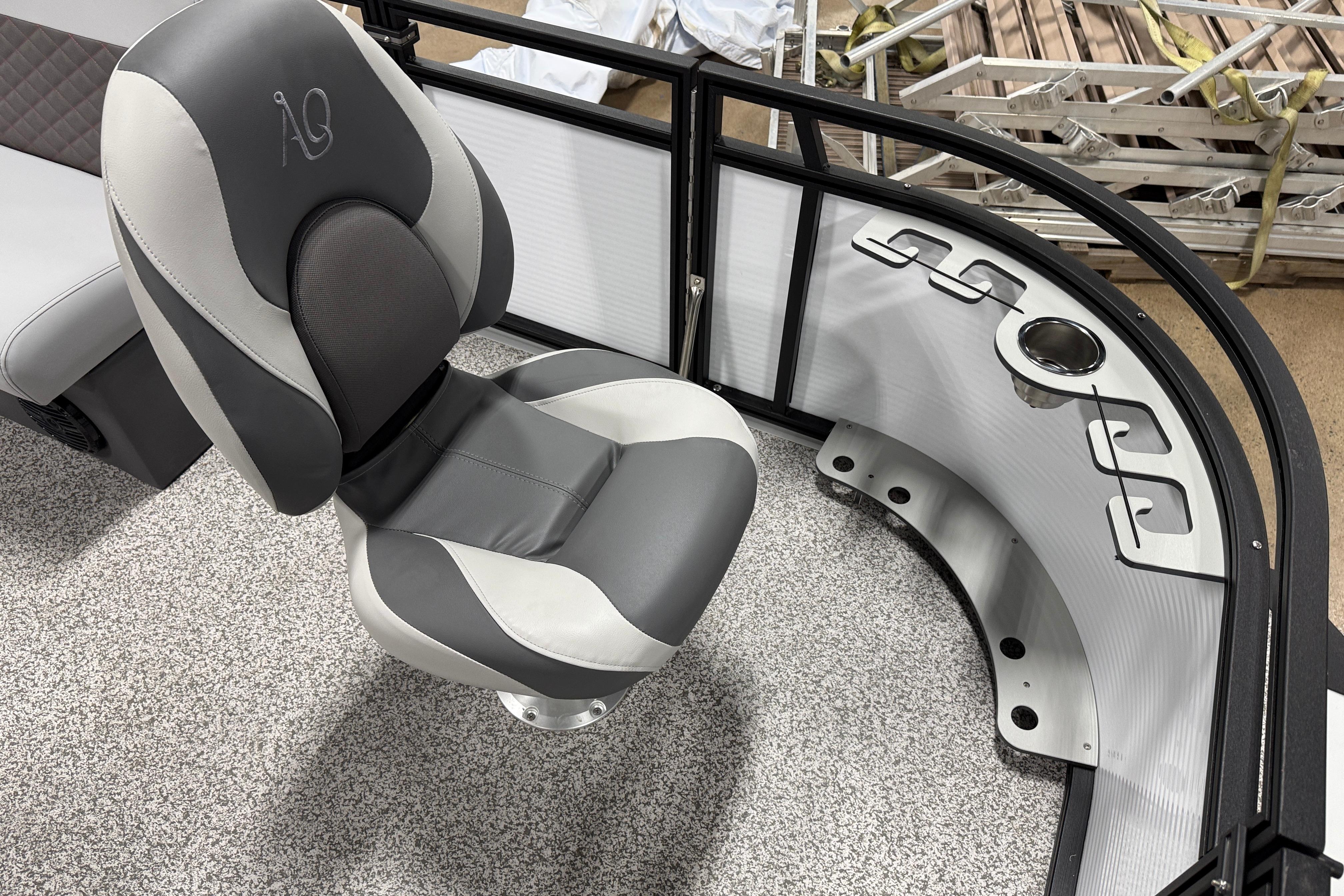 2026 Angler Quest 816 Panfish boat interior with gray seating and rod holders.