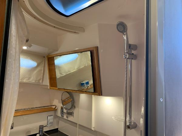 2021 Cutwater C-32 CB bathroom with shower, mirror, and modern fixtures.