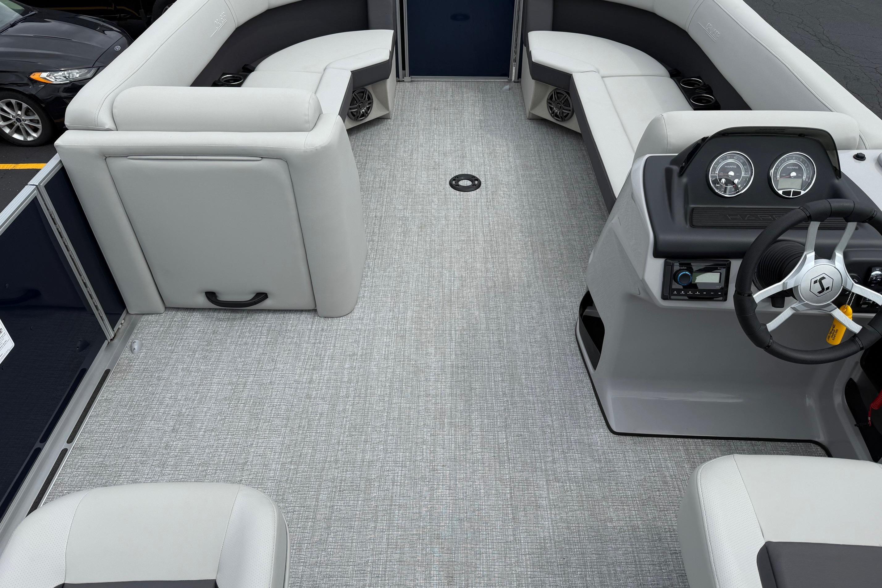 2025 Harris Cruiser 230 boat interior with gray seating and modern dashboard.