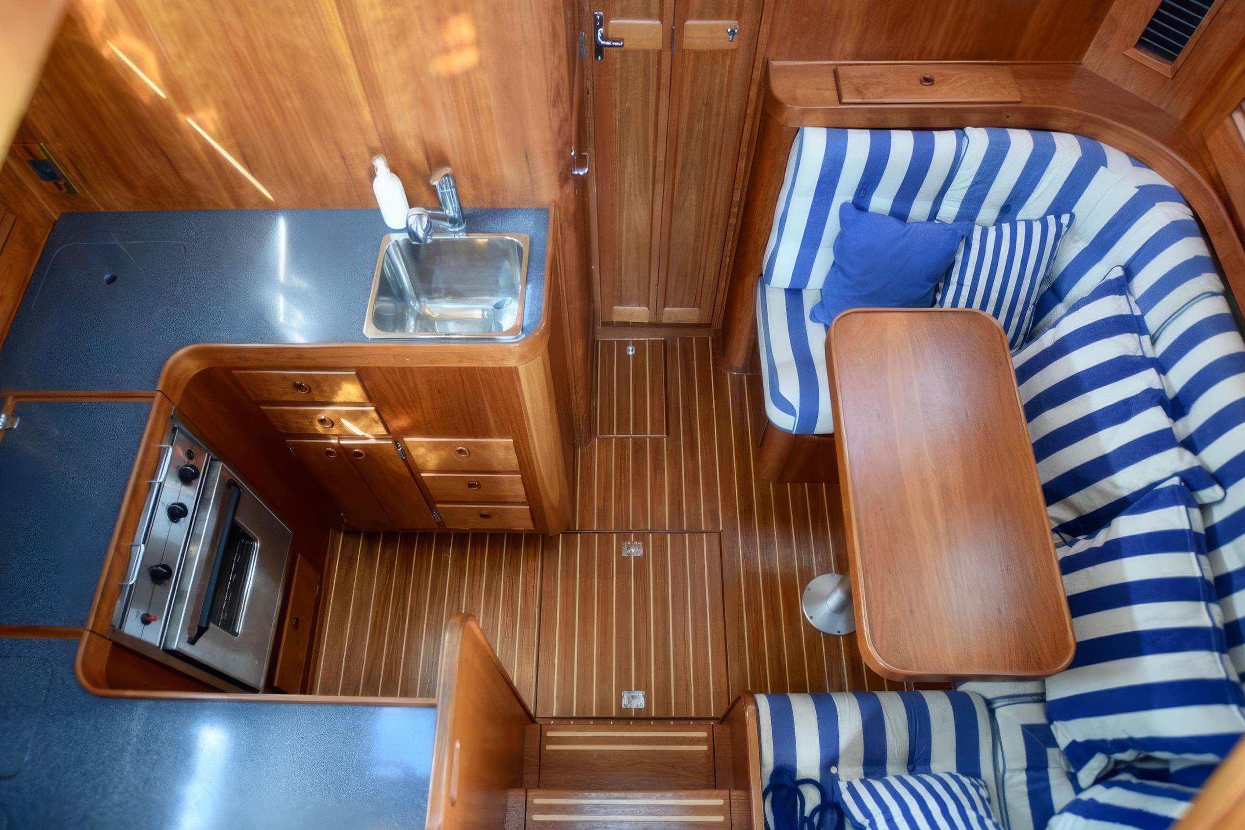 Interior of 2001 Sabreline 36 Express yacht with wood finish and striped seating.