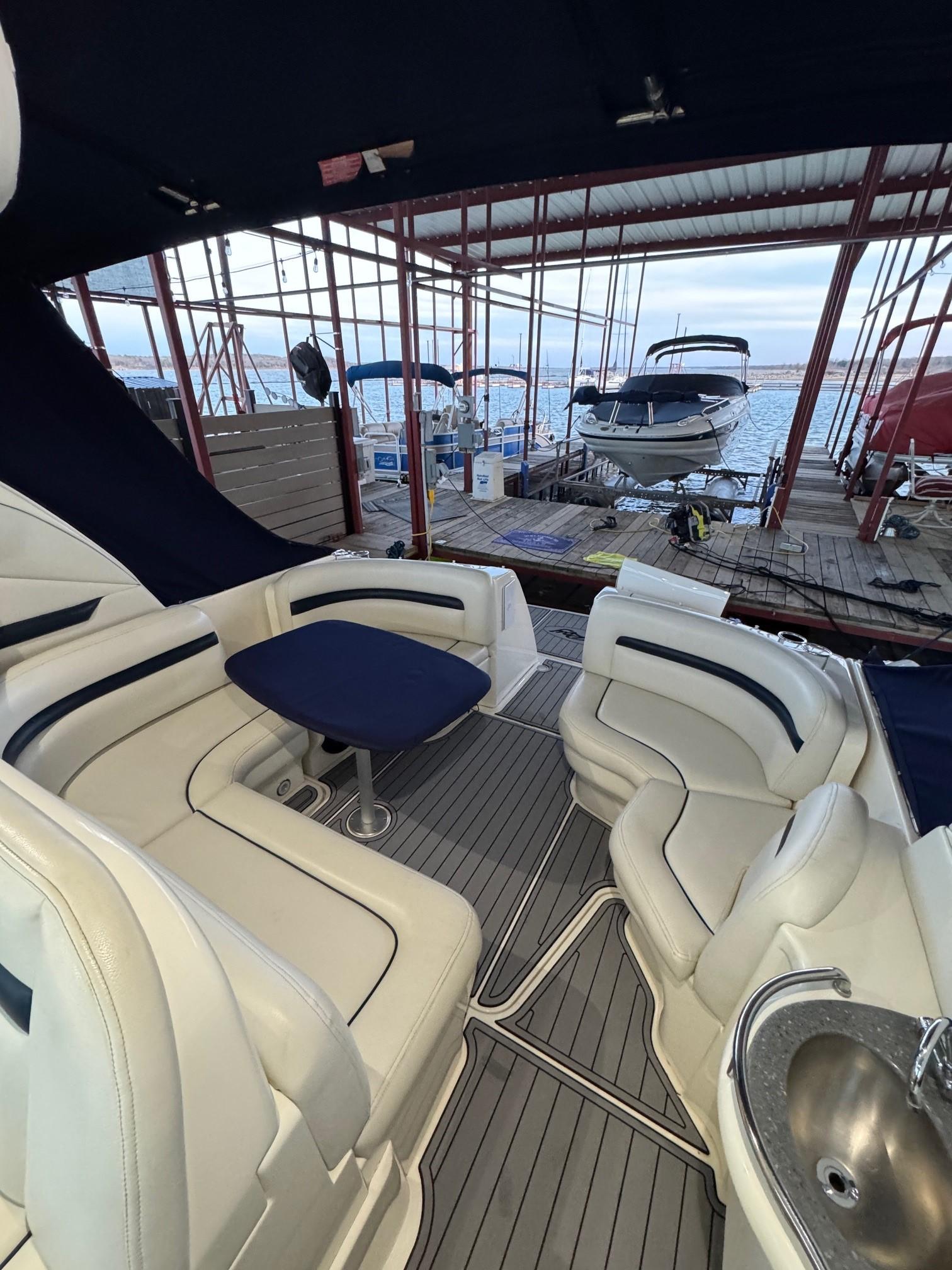 2007 Sea Ray 38 Sundancer interior with seating and table, docked at marina.