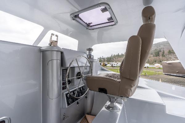 Interior cockpit of 2025 Shuttleworth 52 AeroRig yacht, featuring modern steering and controls.