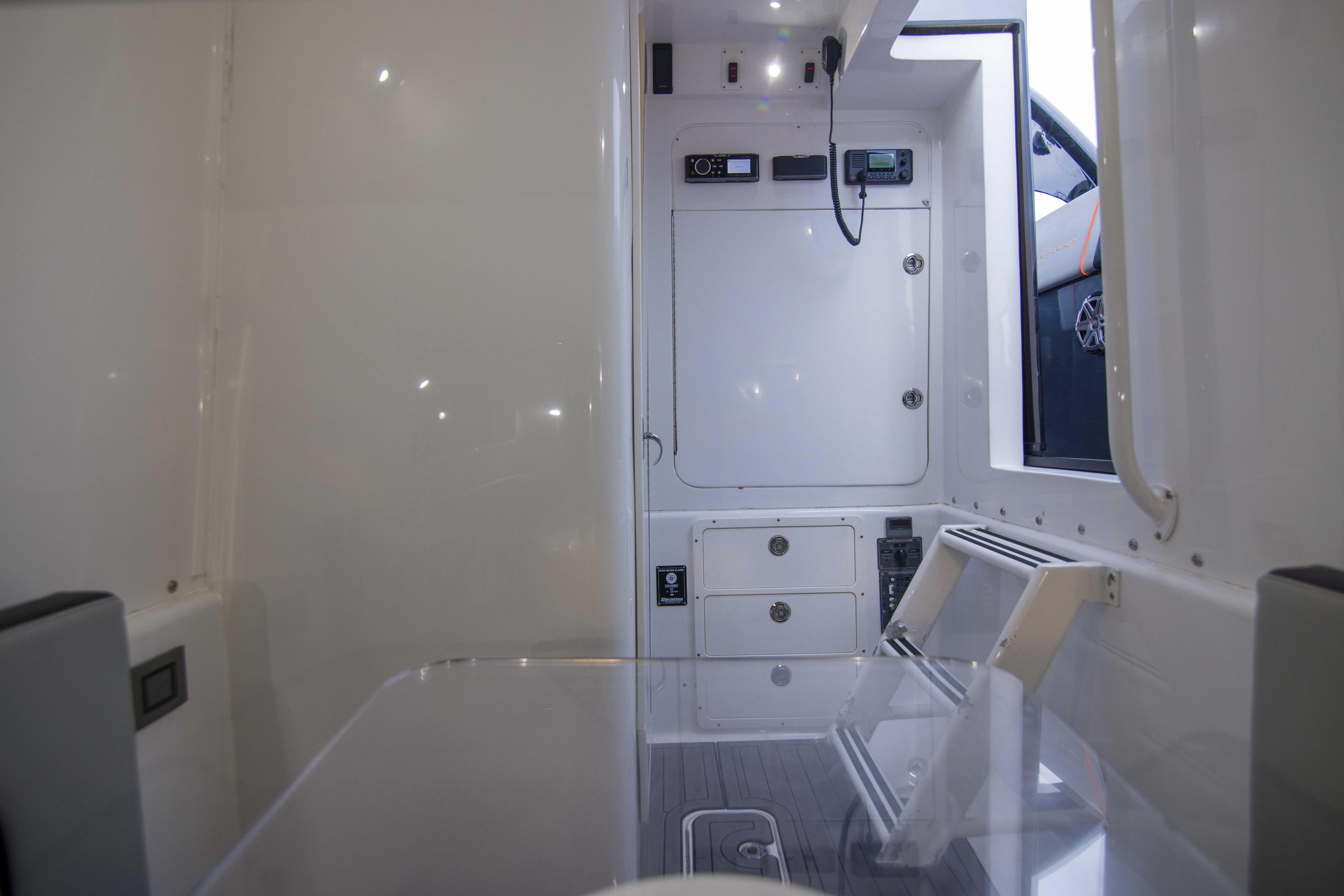 Interior of a 2019 Midnight Express 43 Open boat, featuring sleek white design and modern controls.