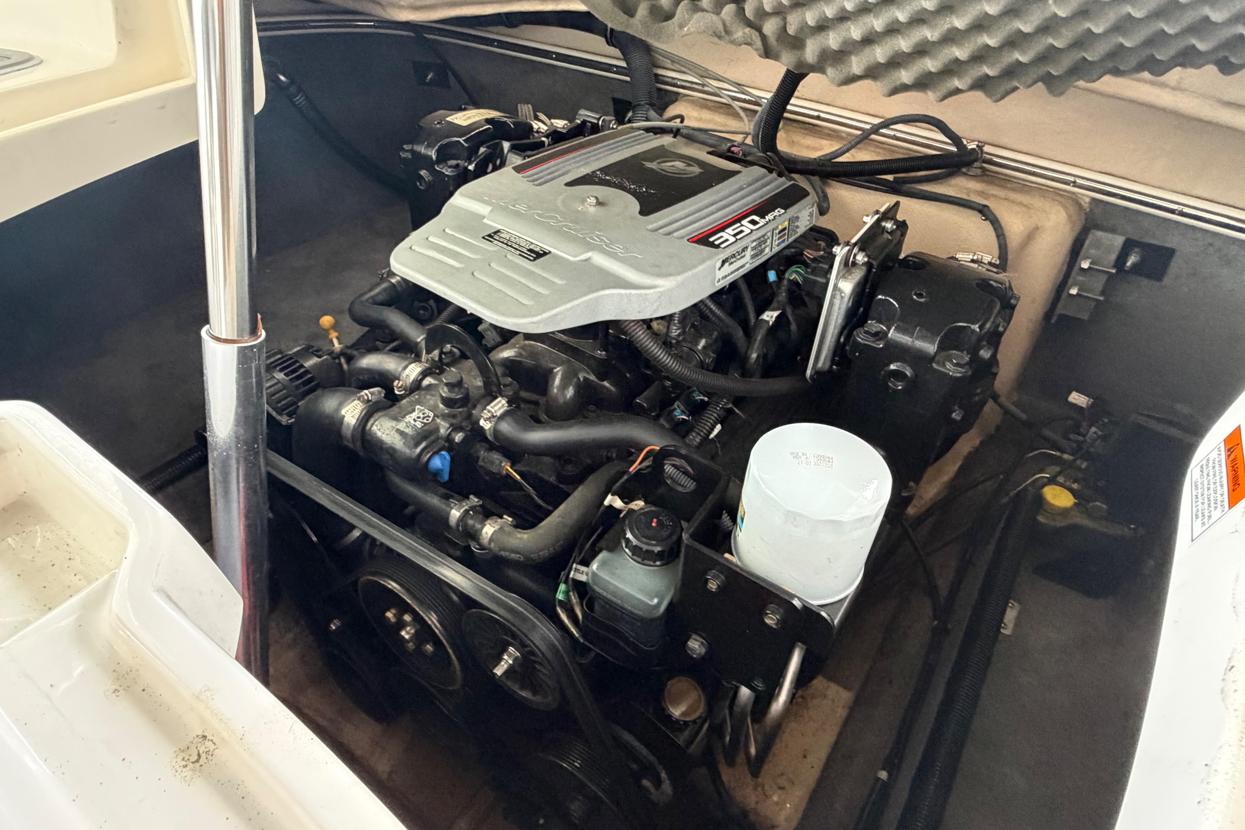 Engine compartment of a 2010 Bryant 255 boat, featuring a 350 MAG engine.