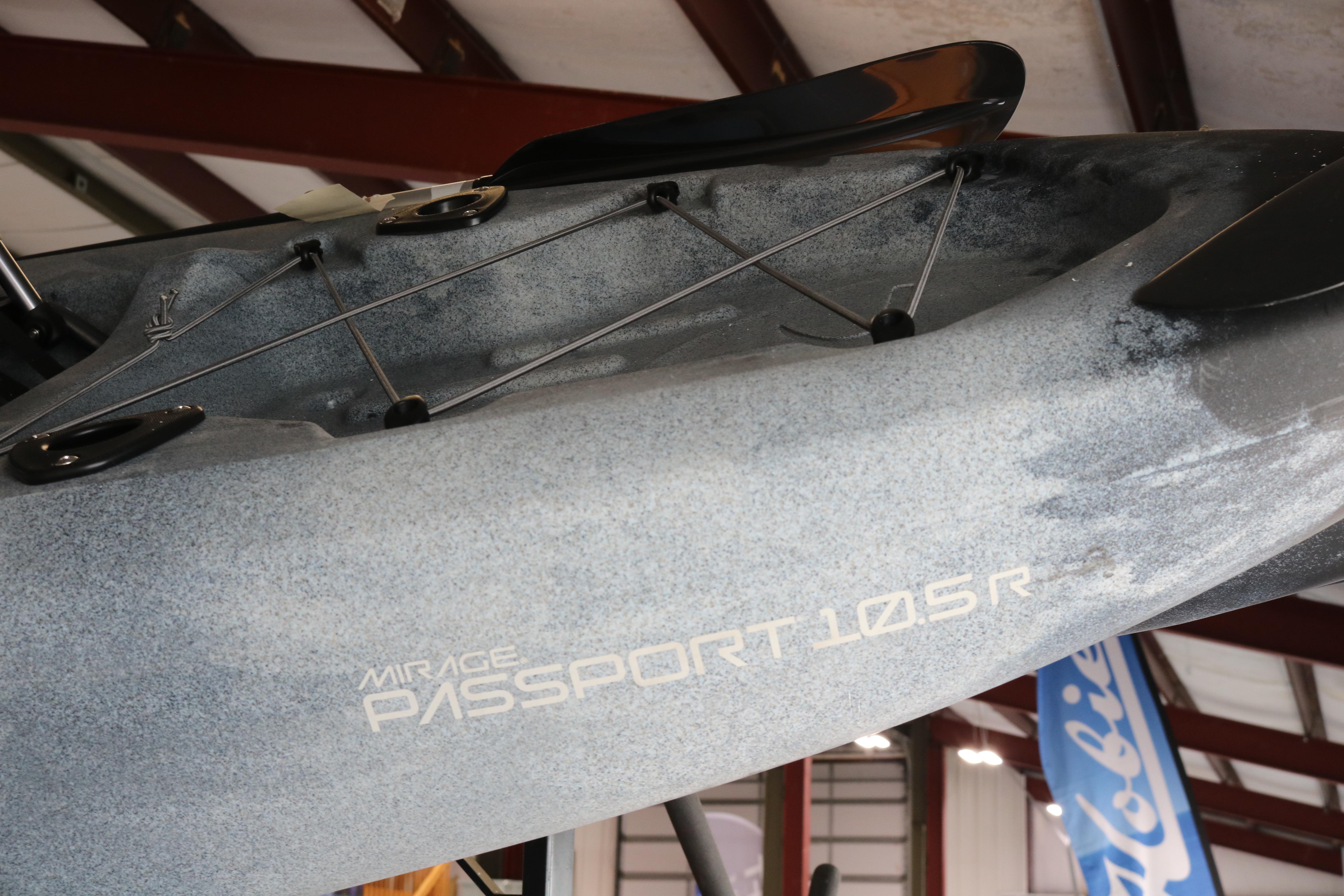 2024 Hobie Mirage Passport 10.5 R kayak displayed indoors, showcasing sleek design and branding.