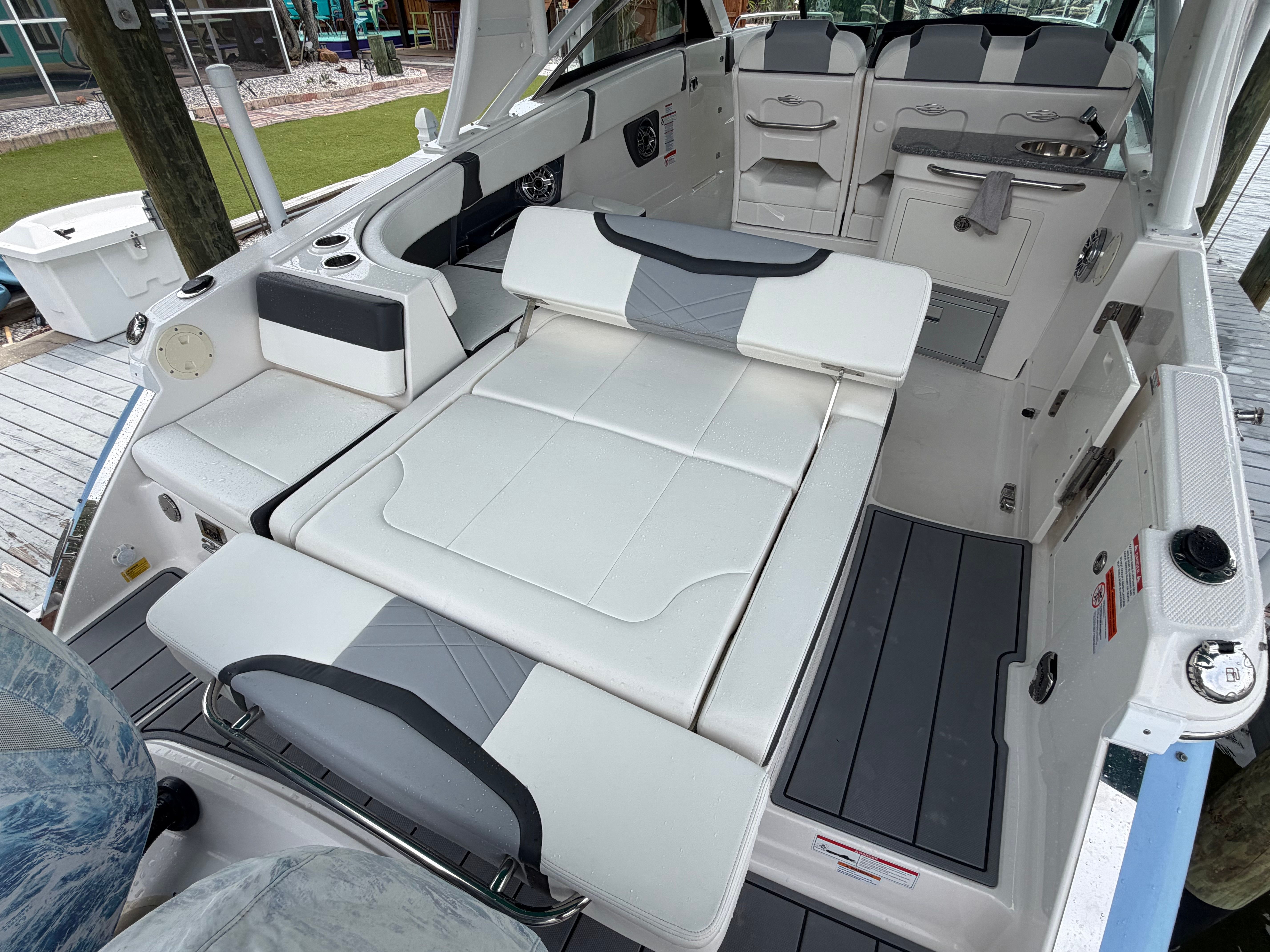 The image shows the cockpit of a Chaparral 280 OSX boat with white upholstery.