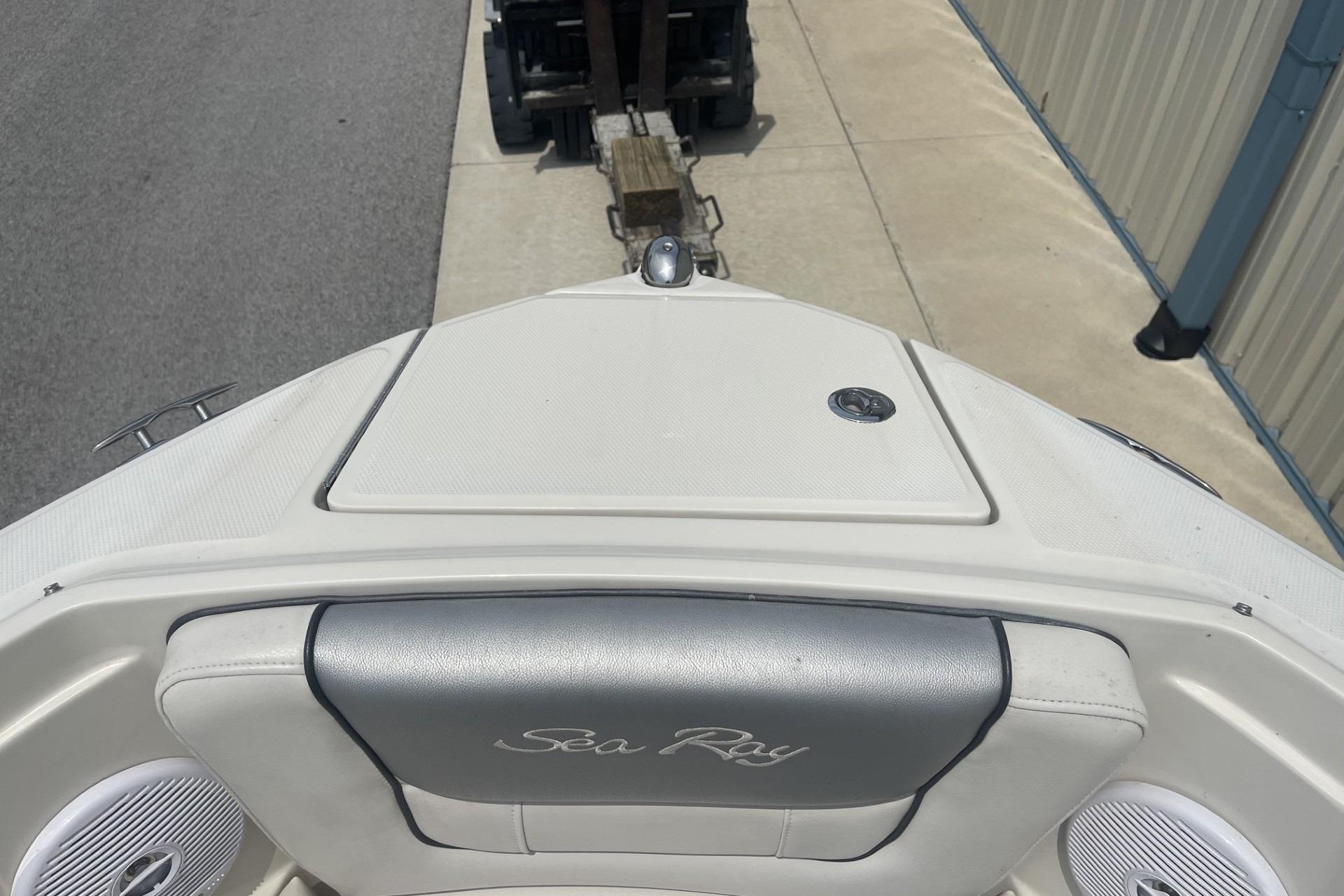 2010 Sea Ray 230 Bow Rider Select boat docked near a building.