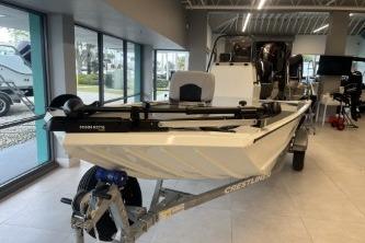 2026 Crestliner 1860 Retriever CC boat displayed indoors on a trailer.