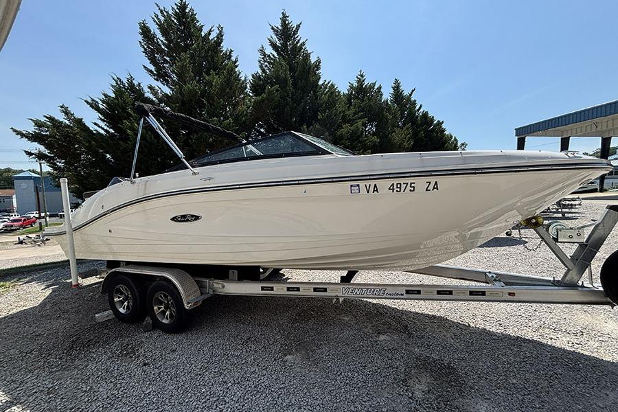 2019 Sea Ray SPX 230 Outboard boat on trailer, parked outdoors.