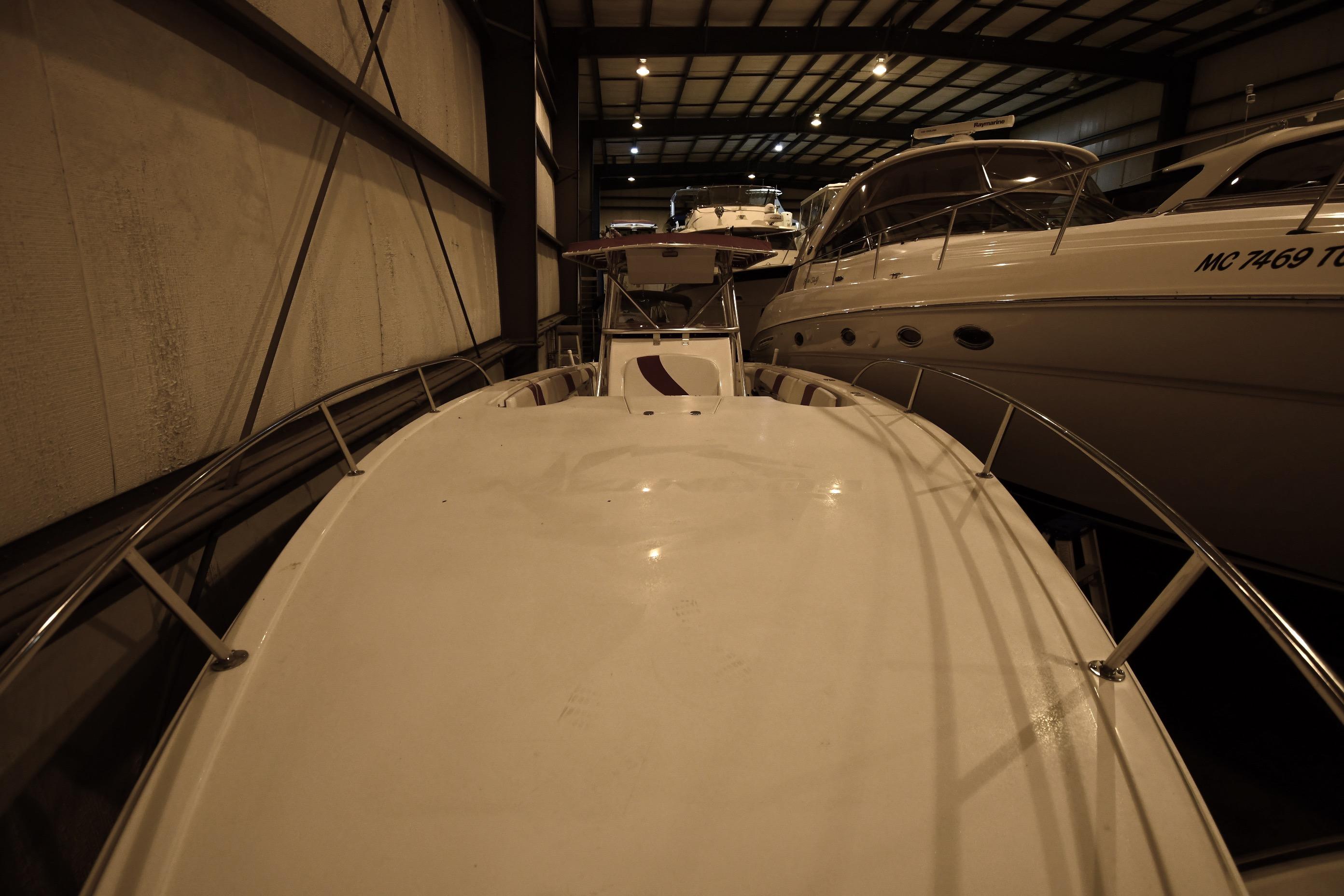 2001 Fountain 38 Center Console boat in indoor storage, surrounded by other vessels.