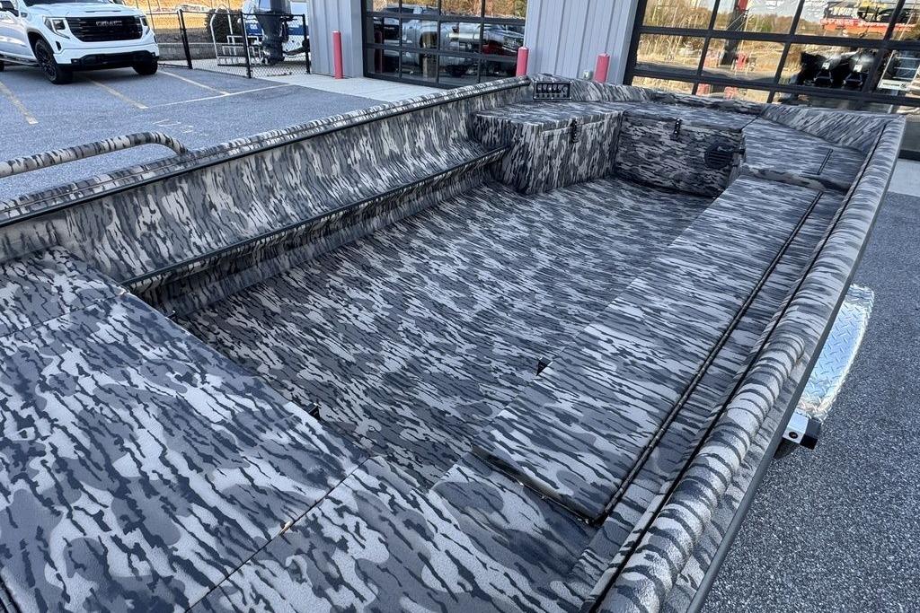 2026 Havoc 1756 boat with camouflage interior, parked outdoors near a building.