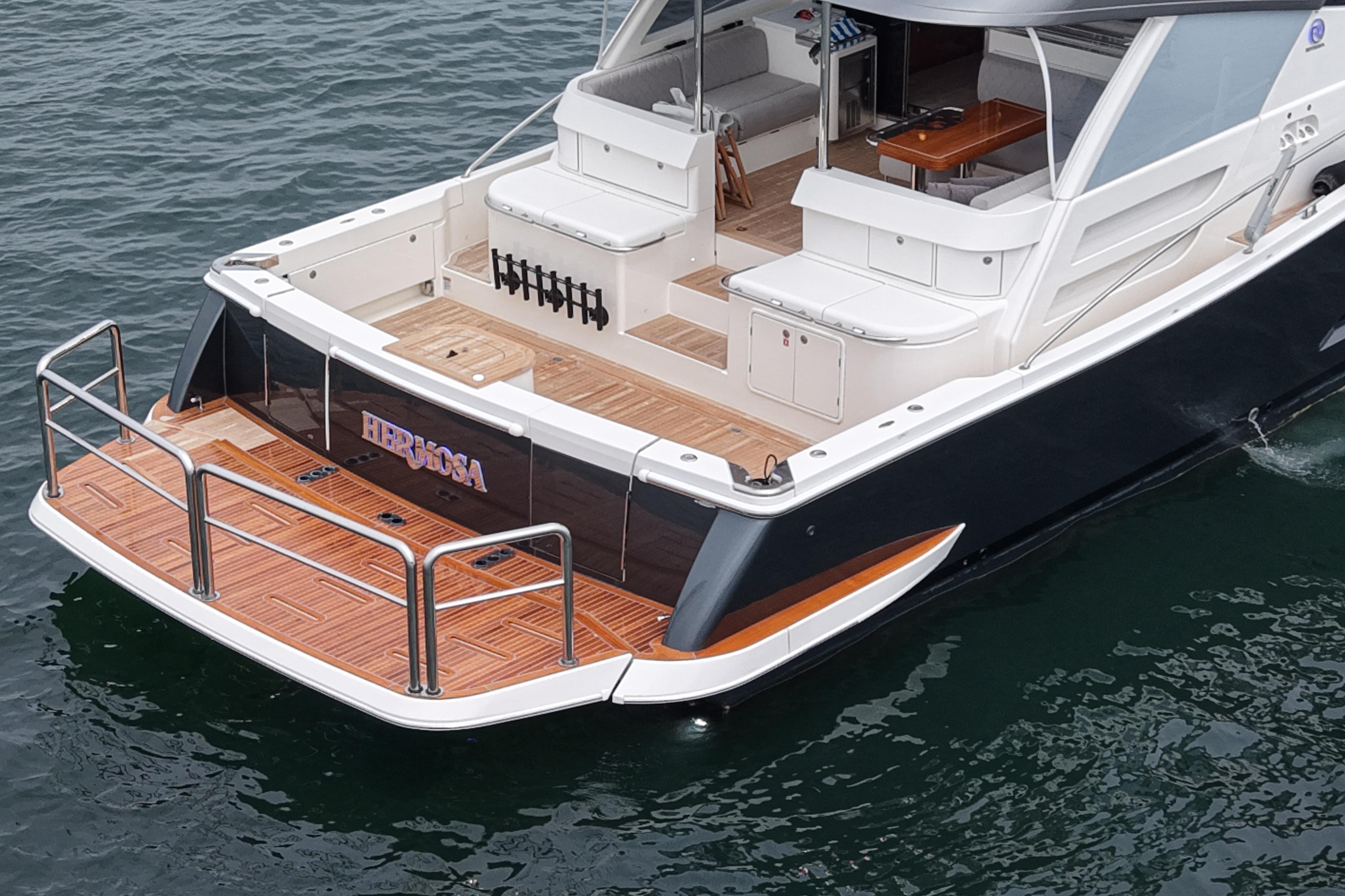 2023 Riviera 645 SUV yacht with elegant deck design on calm water.