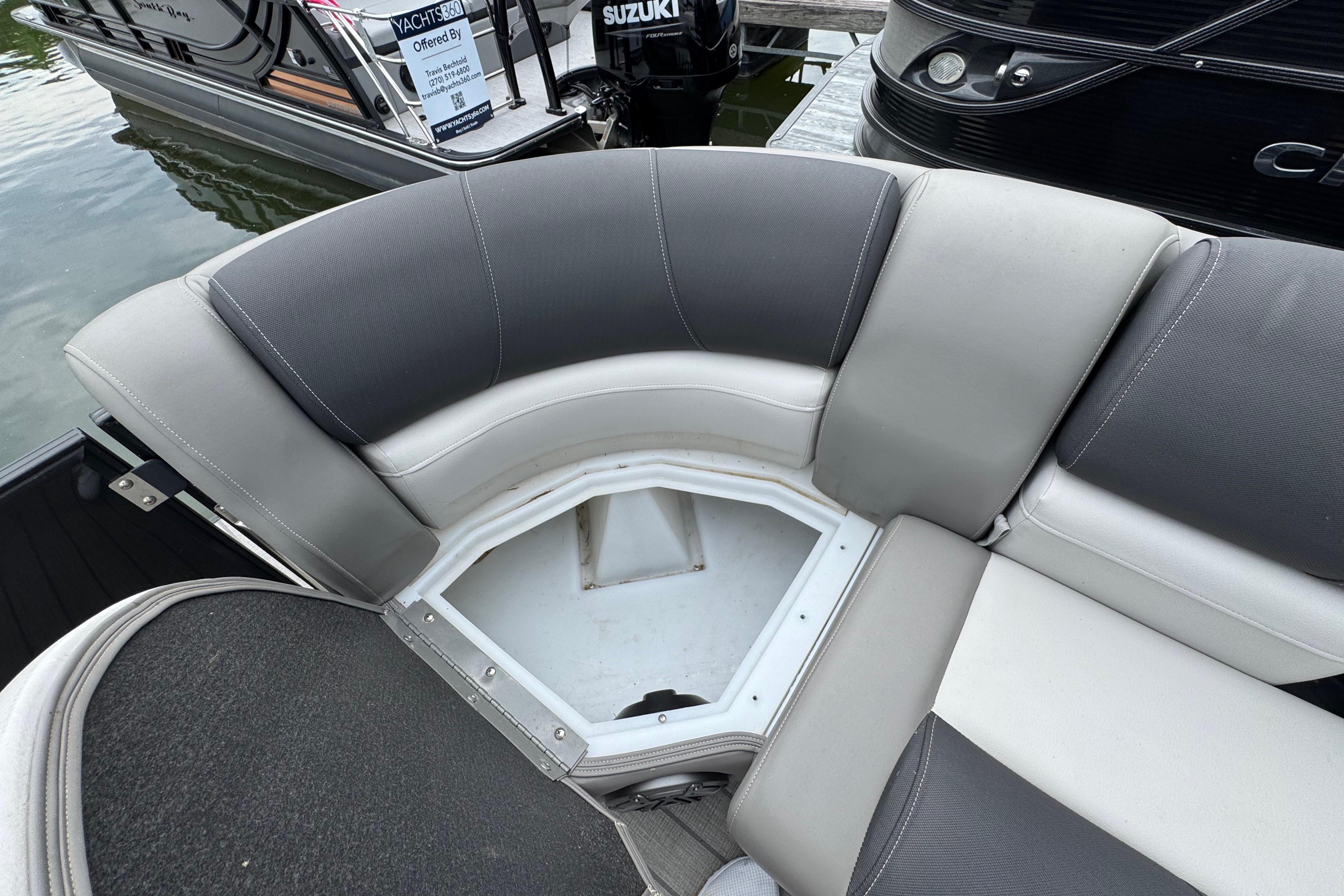 2023 Starcraft MX 25 DL DH boat with open storage compartment on cushioned seating.