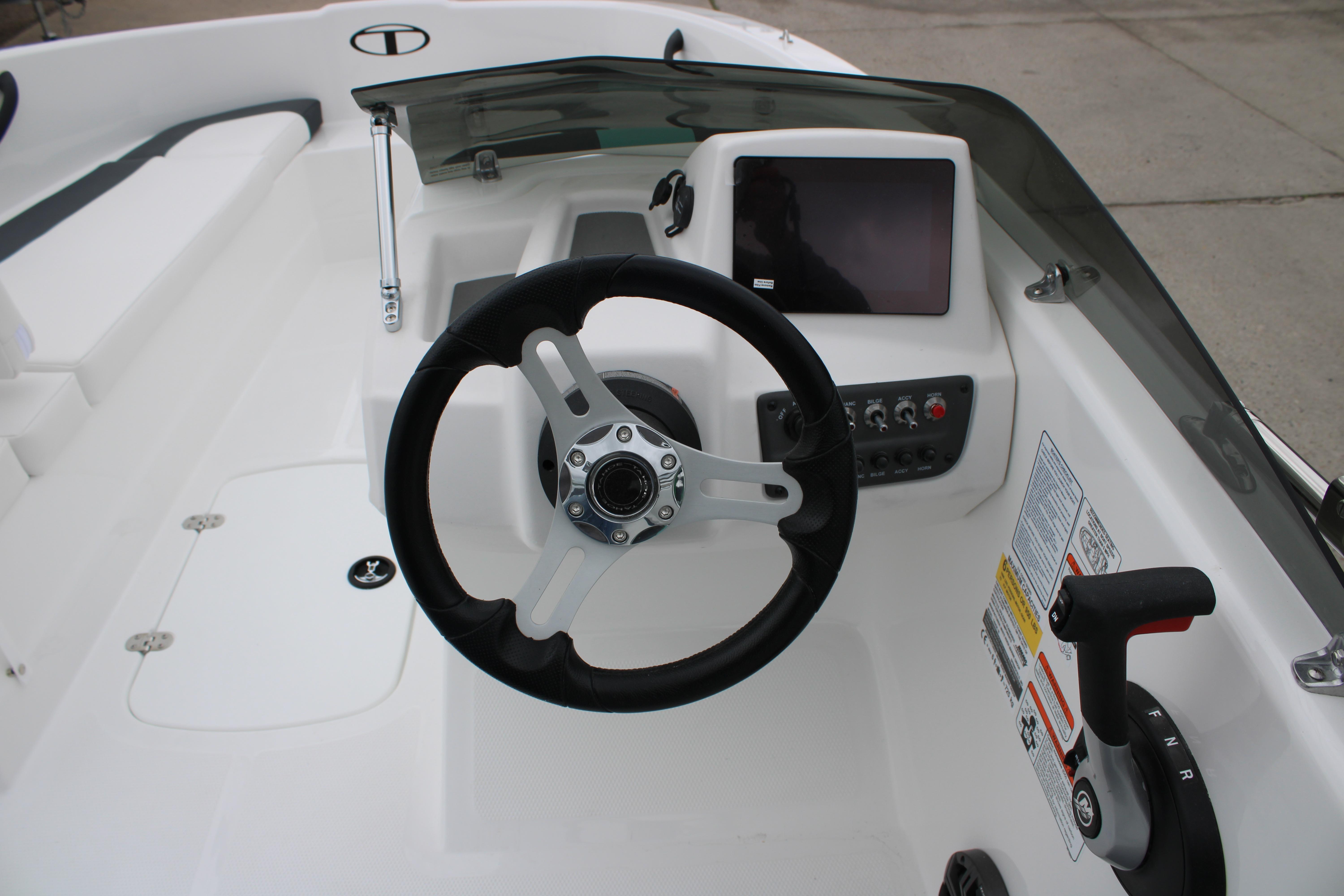 Steering console of 2026 Tahoe T16 boat with modern controls and dashboard.