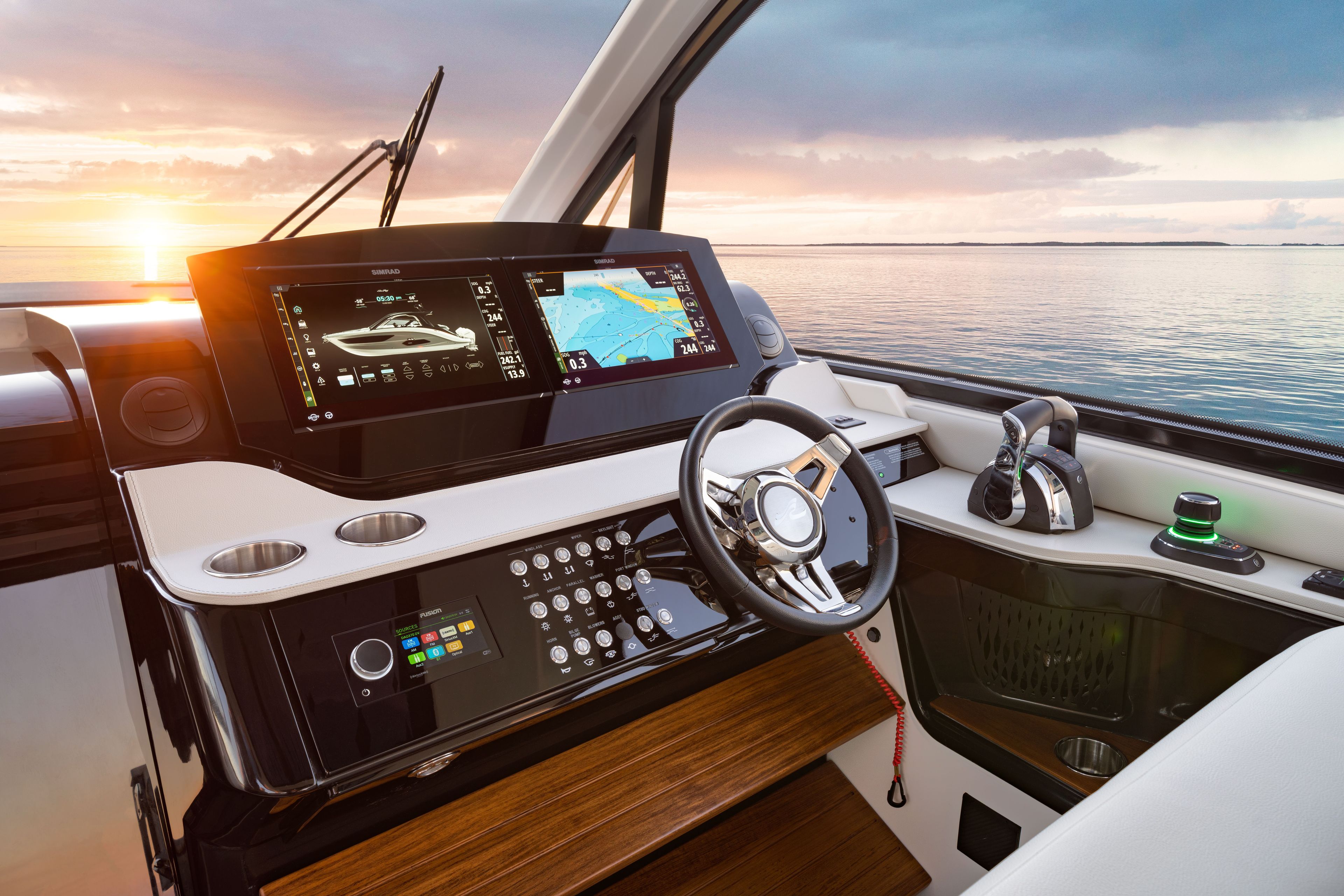 The cockpit of a Sea Ray Sundancer 370 Outboard with modern instruments and a stunning sea view.
