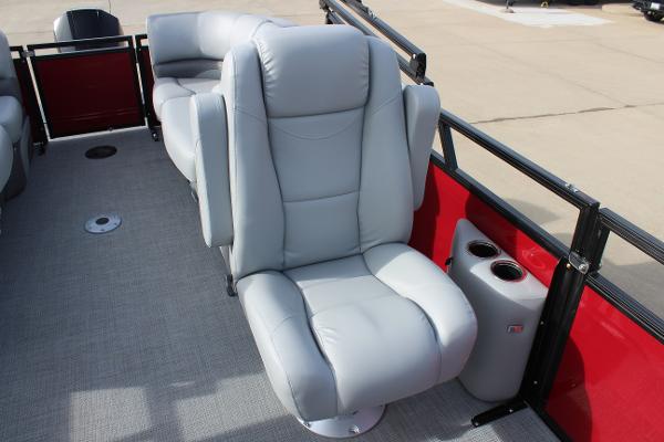 Luxurious seating on 2025 Regency 230 DL3 pontoon boat with red accents.