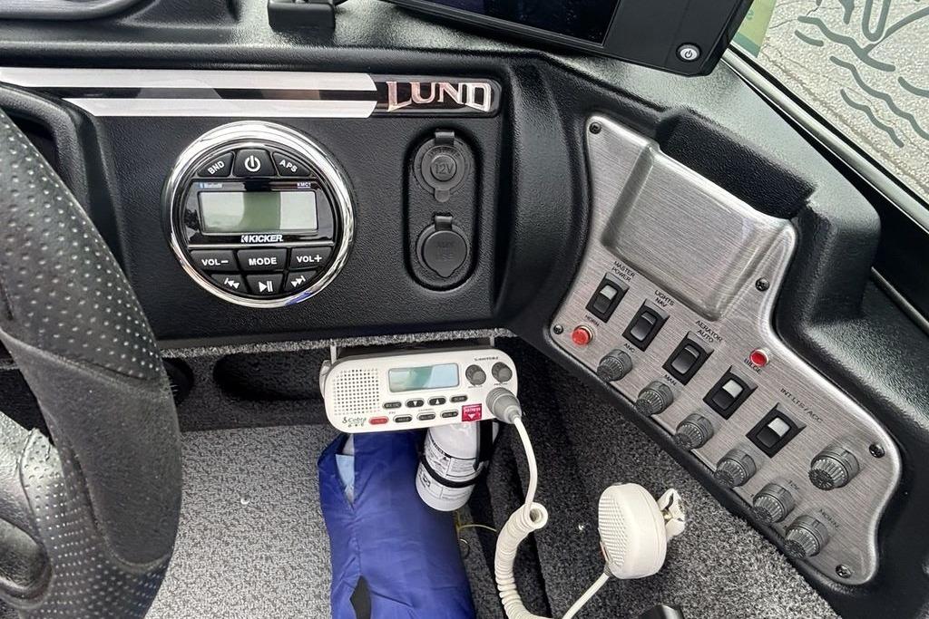 Control panel of a 2021 Lund 1675 Adventure Sport boat with audio and switch controls.