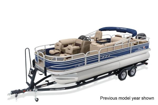 A Sun Tracker Fishin' Barge 22 DLX pontoon boat on a trailer.
