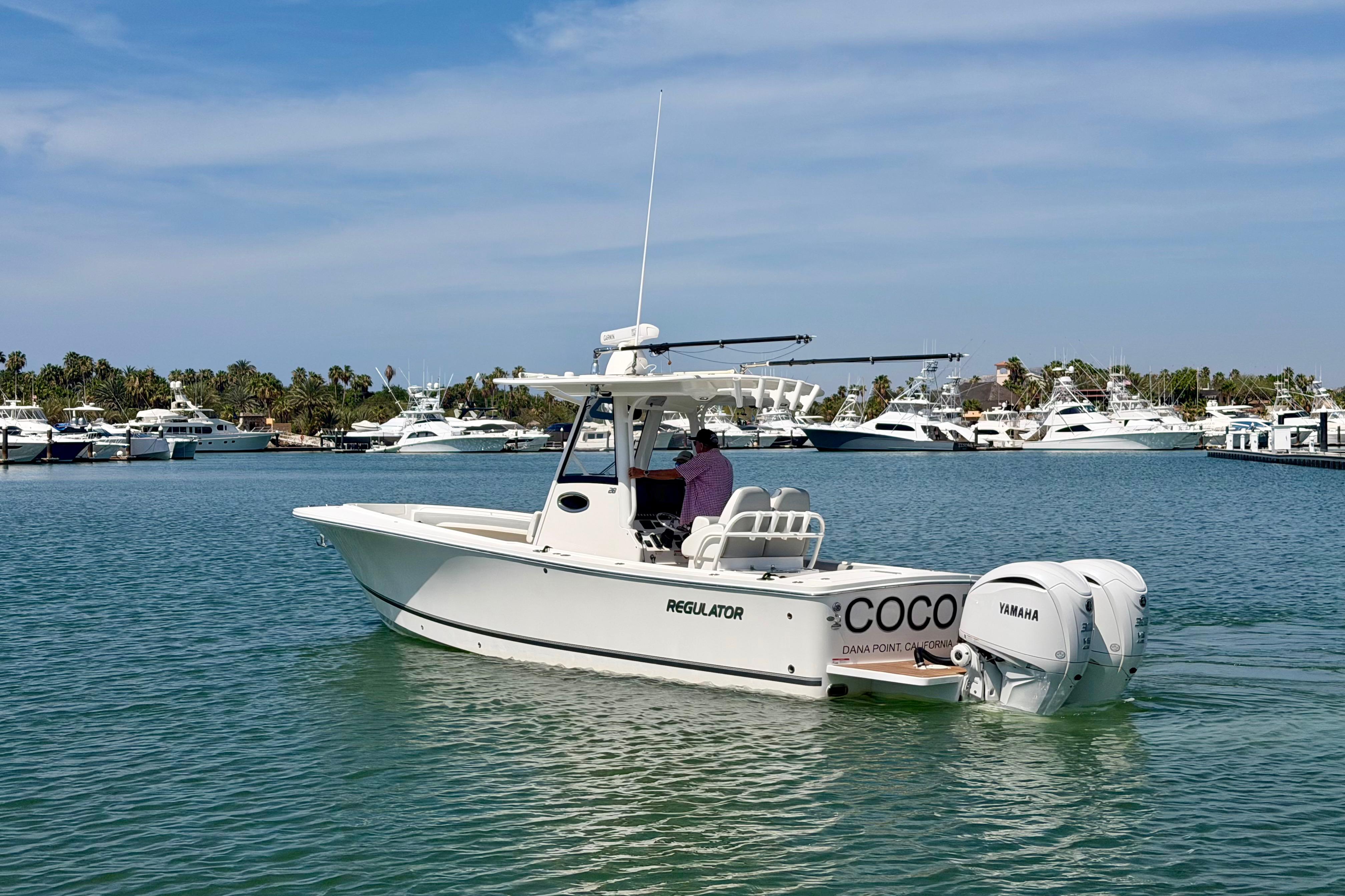 2022 Regulator 28 boat on water, featuring twin Yamaha engines, docked at marina.