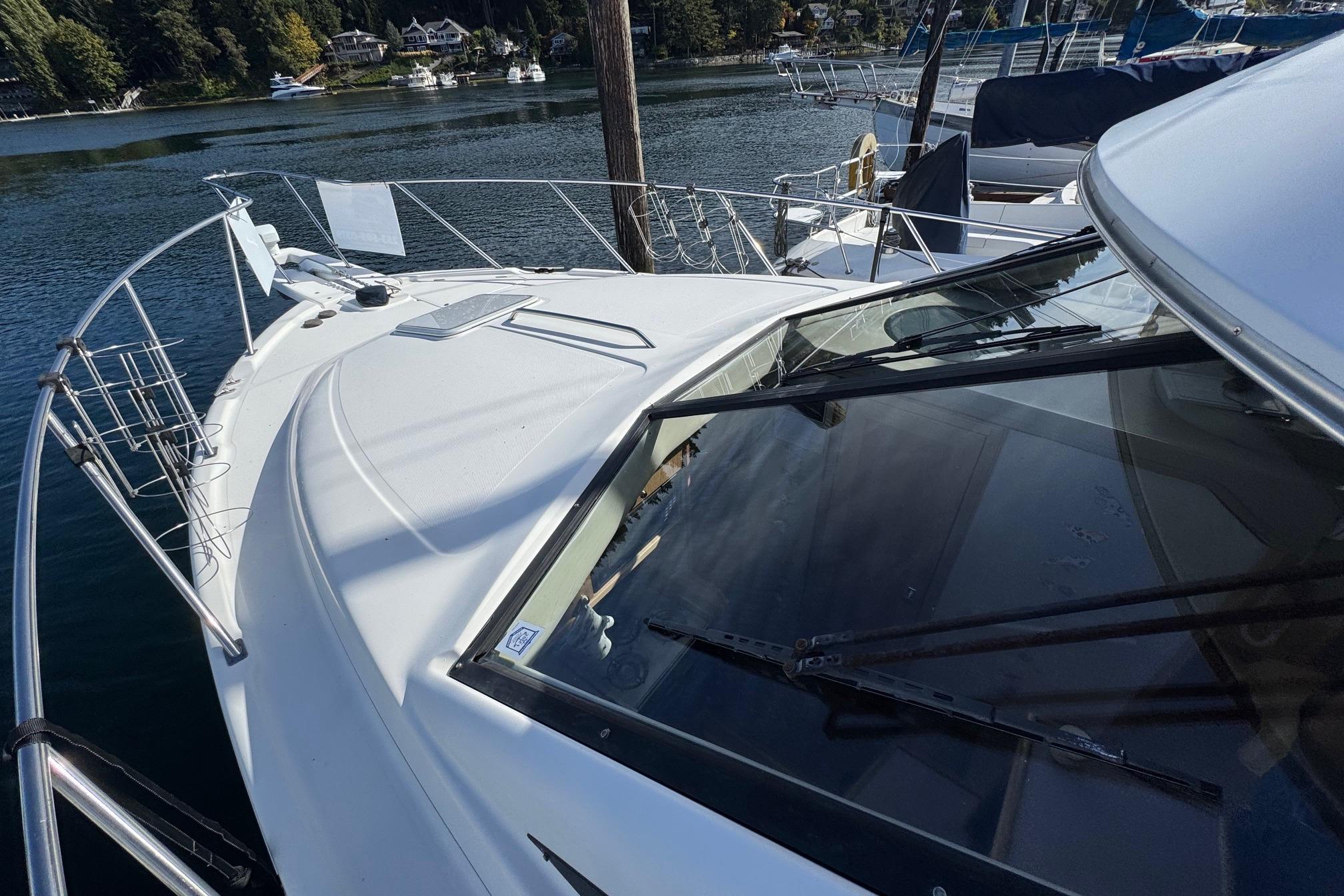1998 Bayliner 3388 Command Bridge Motoryacht docked in a scenic marina.