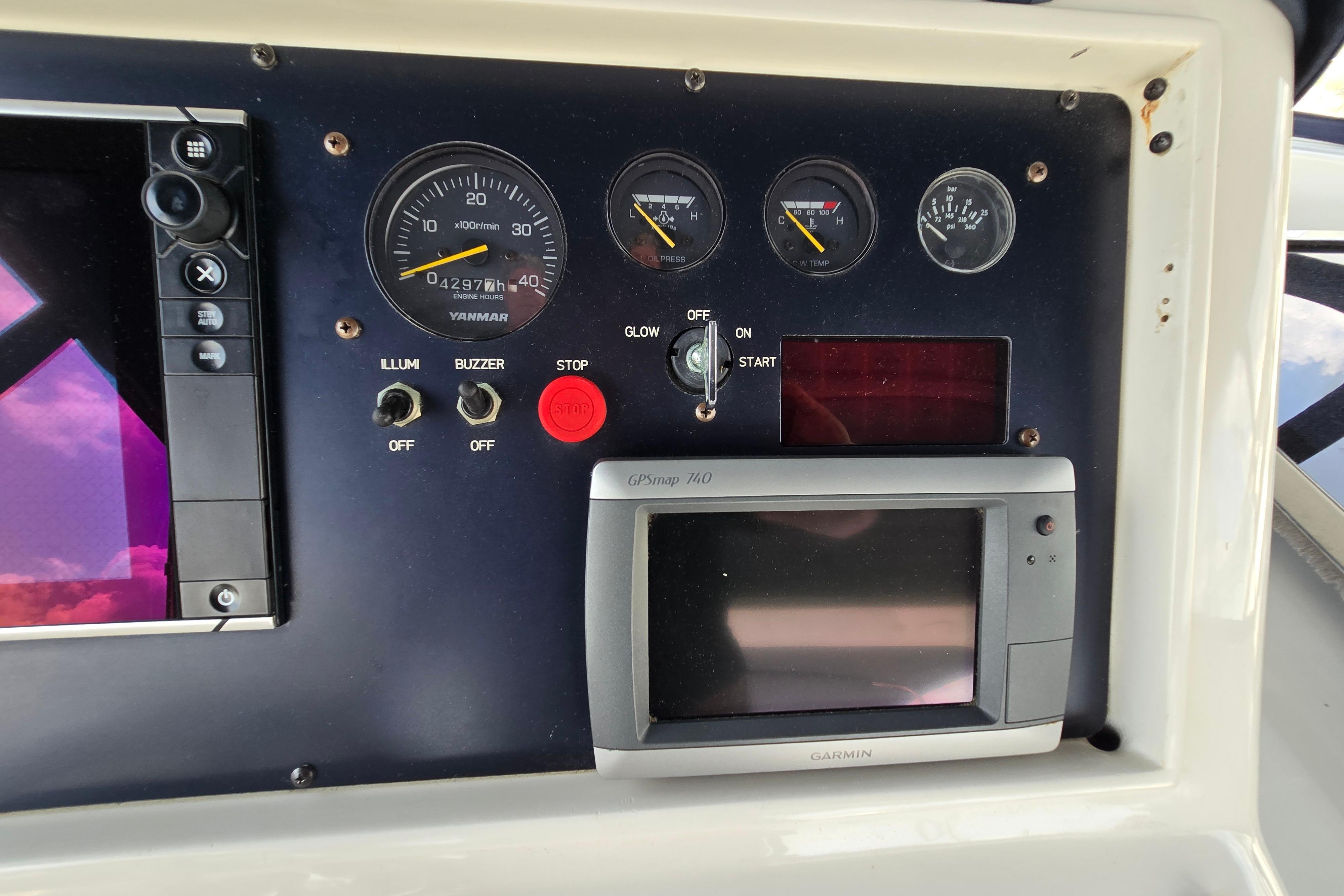 Control panel of a 2004 Grand Harbour 58 yacht with gauges and Garmin GPS.