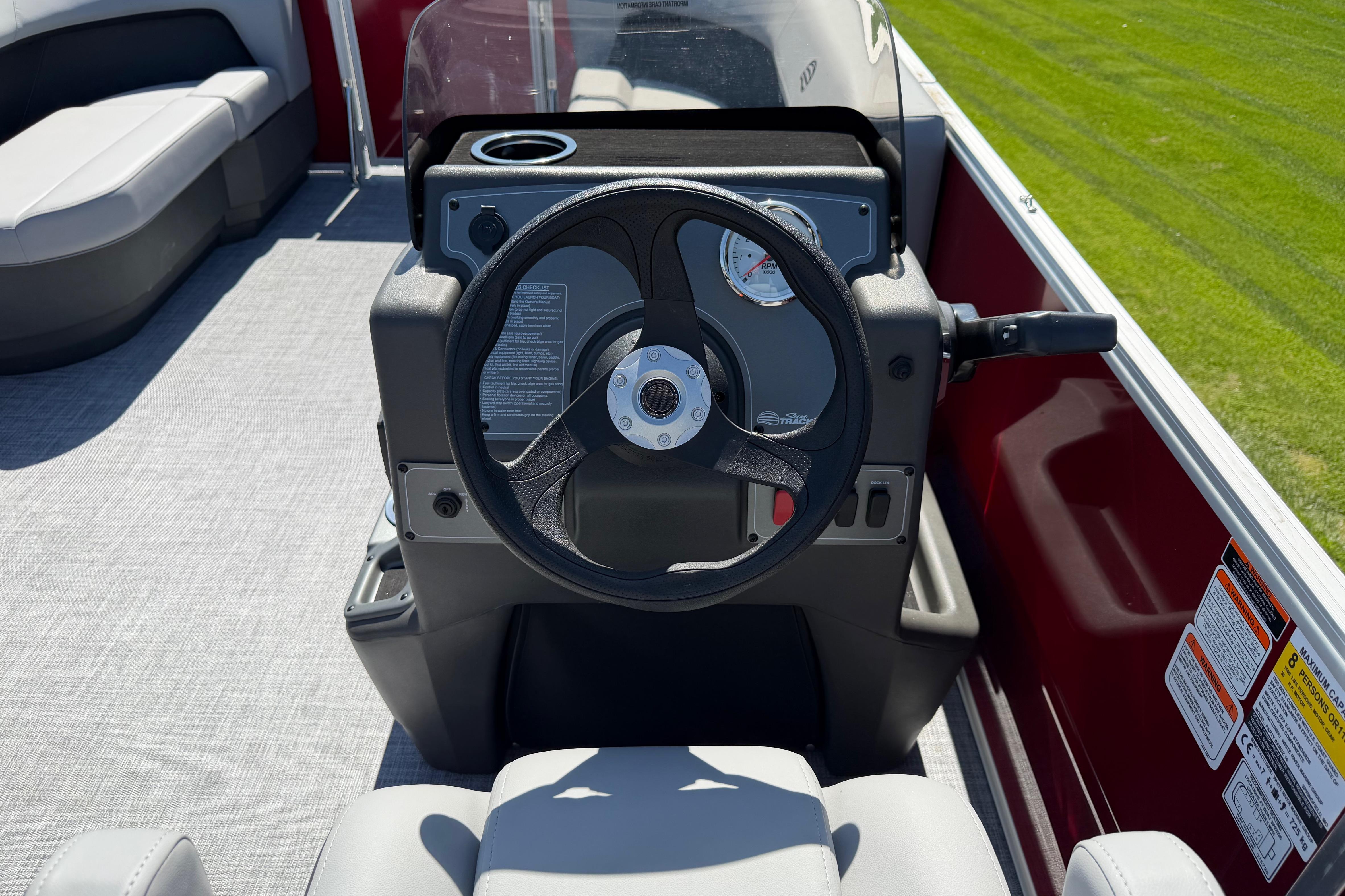 Steering console of 2026 Sun Tracker Party Barge 16 DLX pontoon boat.