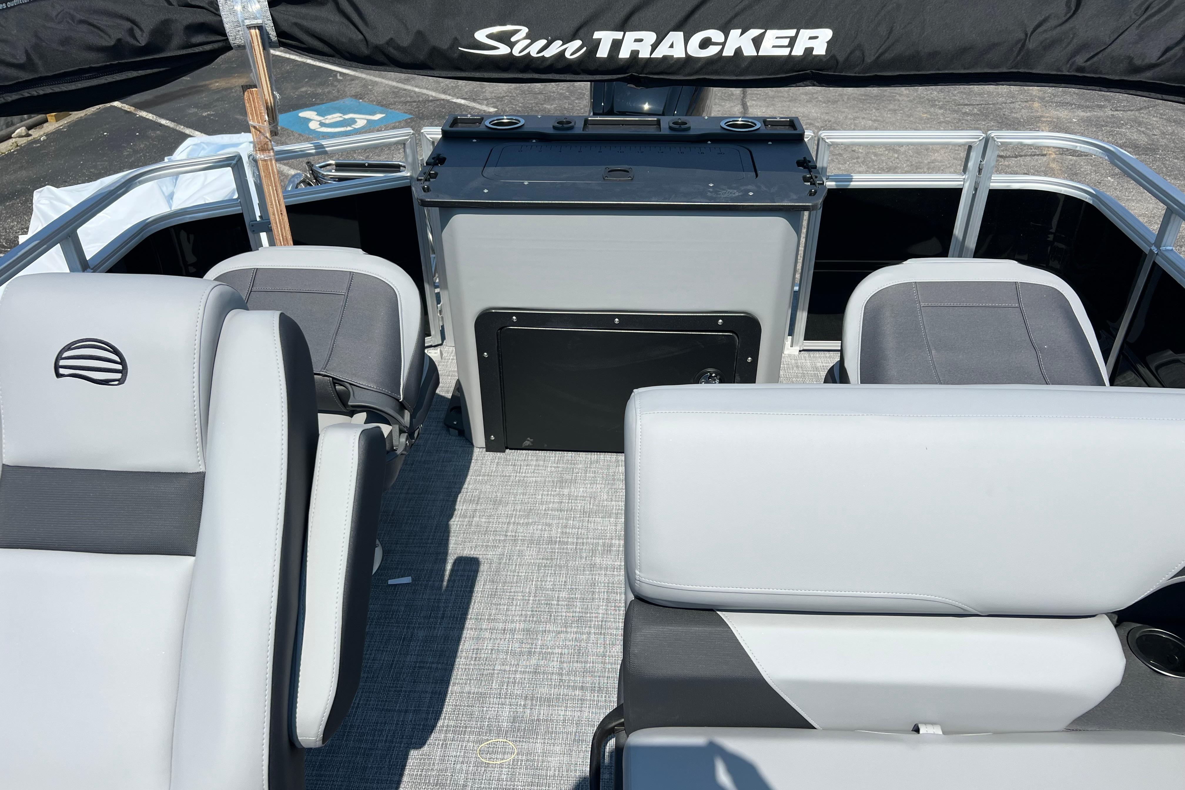2026 Sun Tracker SportFish 20 DLX interior with gray seating and helm station.